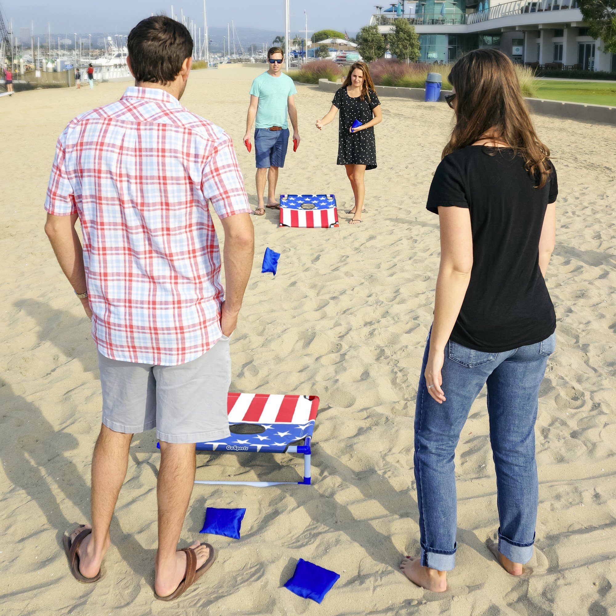 a man and woman playing with a kite on the beach