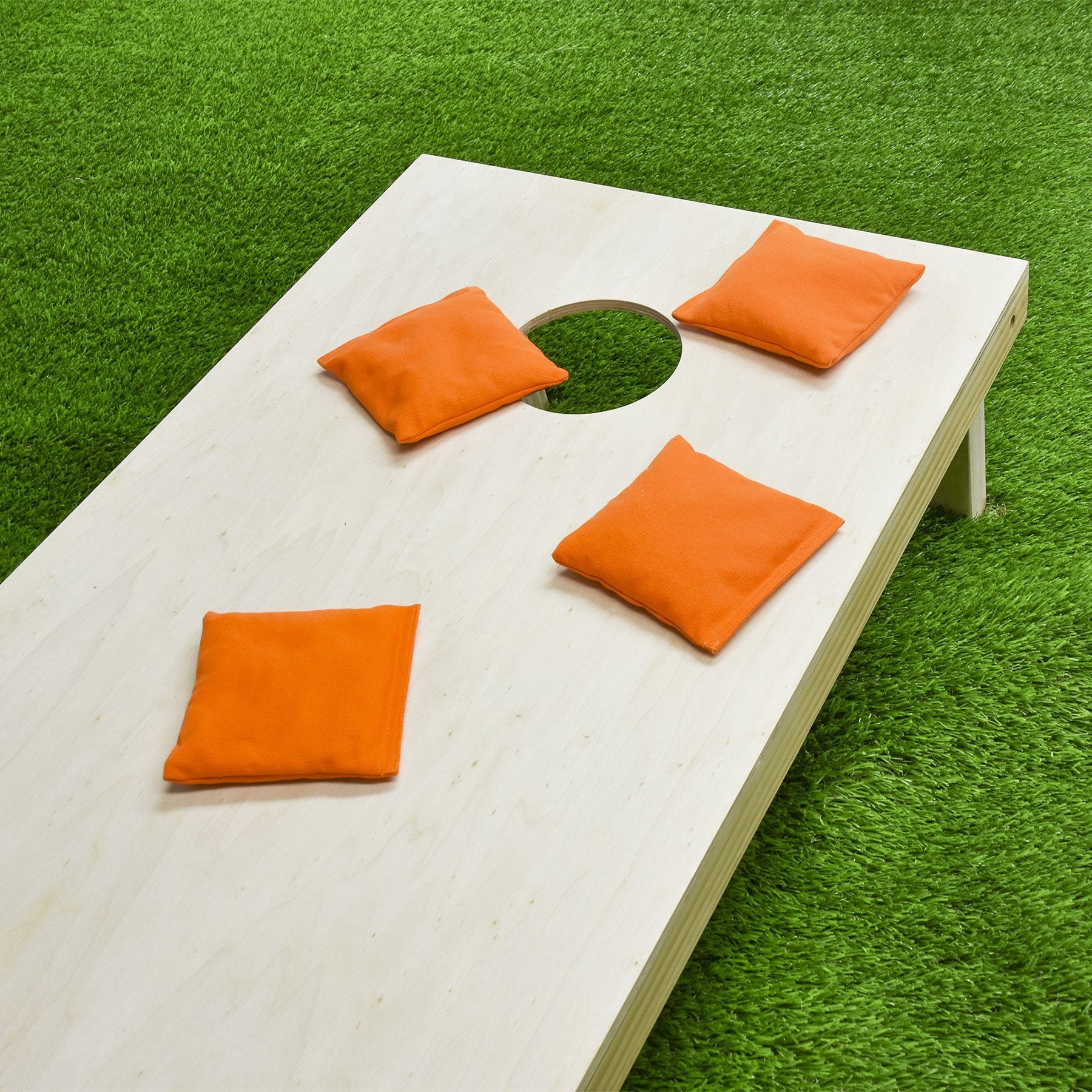 a wooden table with orange cushions on it