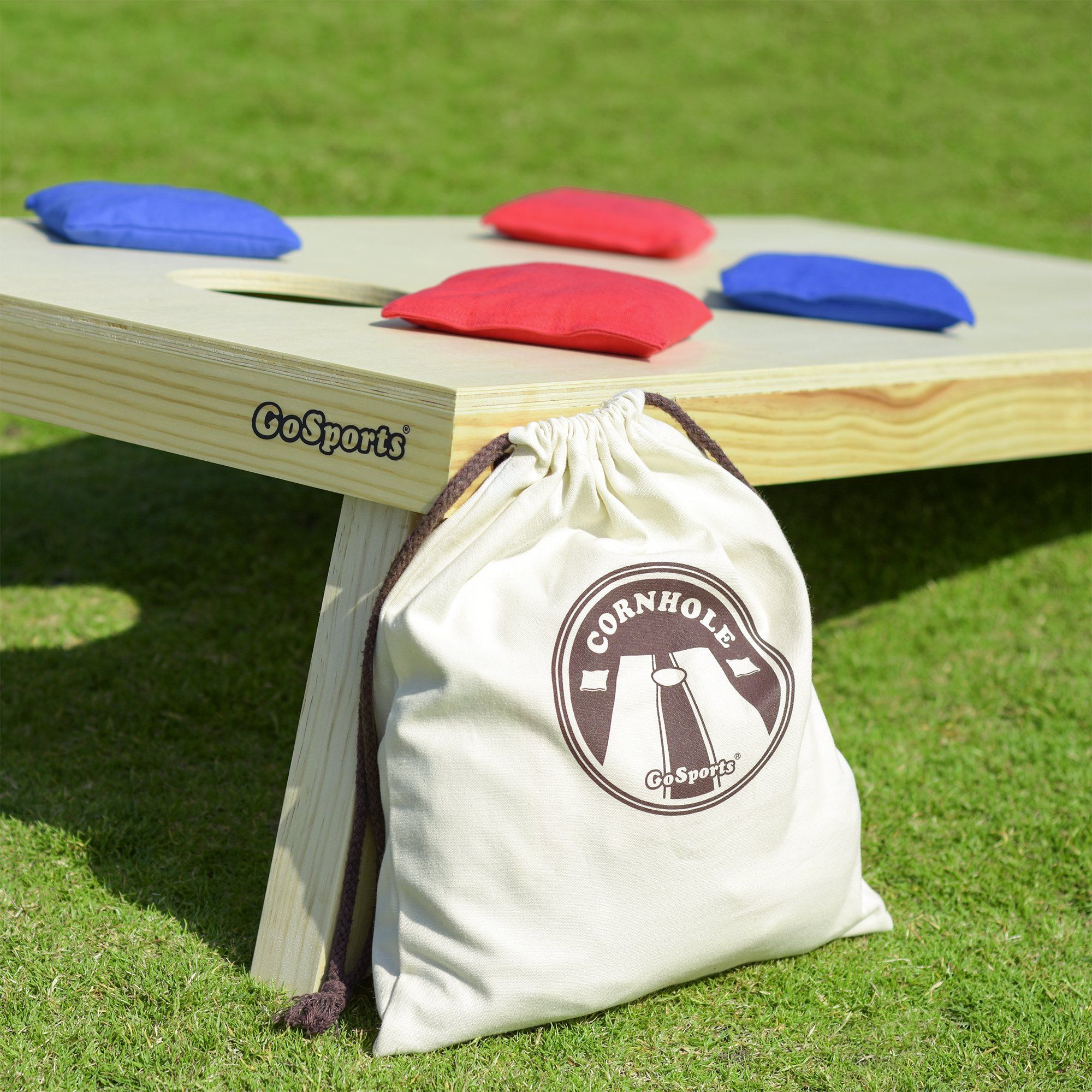 a bag sitting on a wooden bench with a bag on it