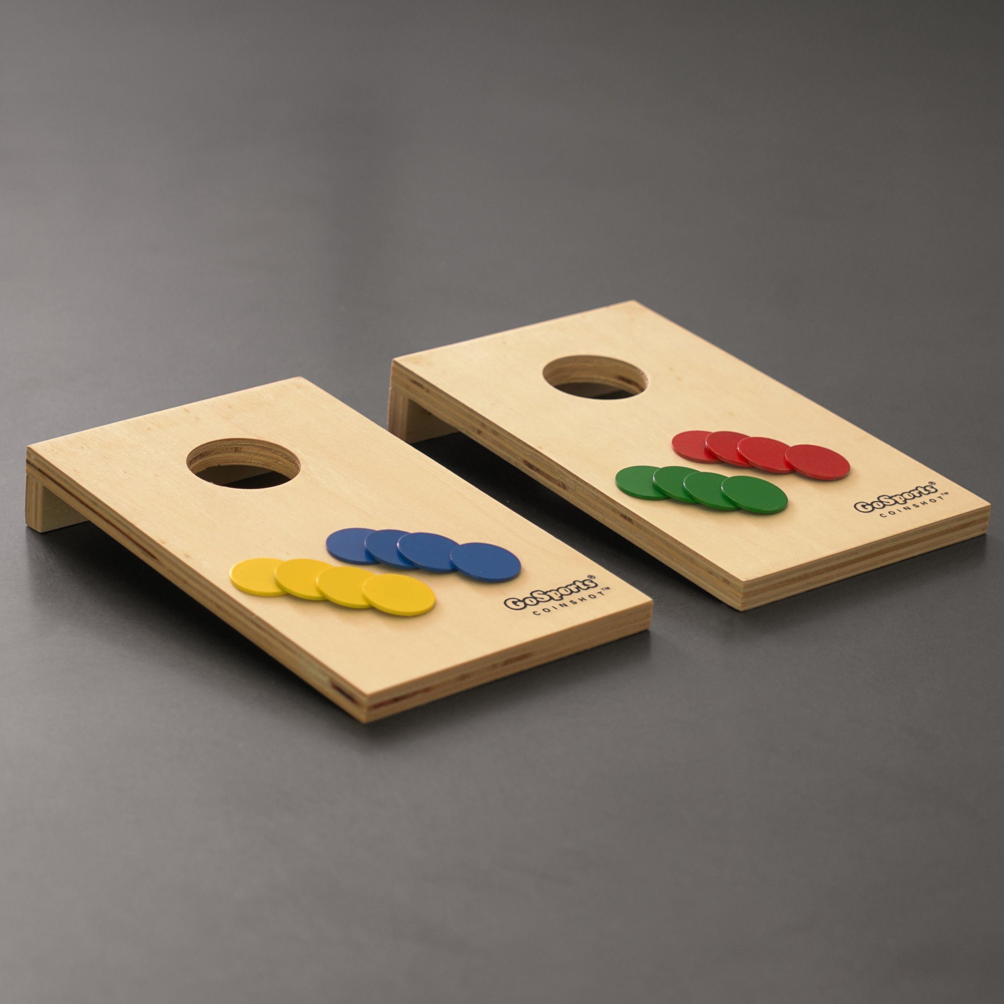 two wooden corno game pieces with colorful buttons