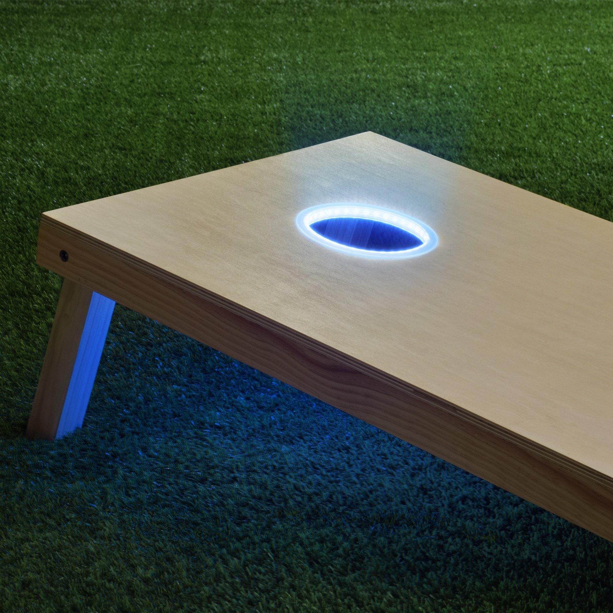 a wooden table with a lit hole in the middle