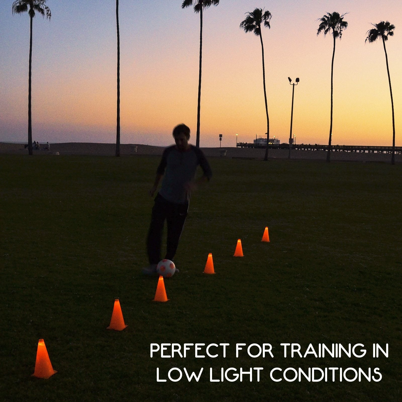 a man is kicking a soccer ball in a field