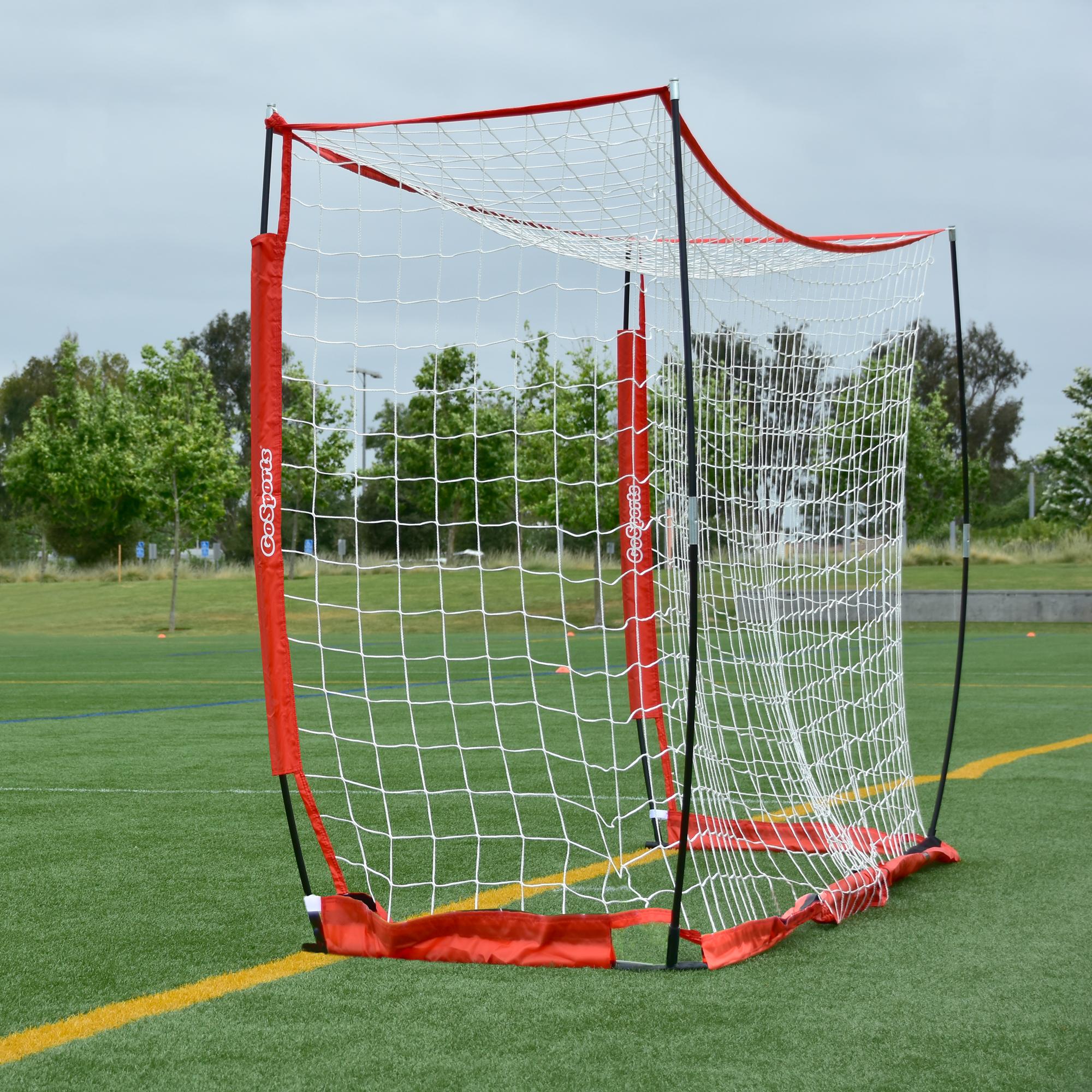 a soccer goal with a red net on a field