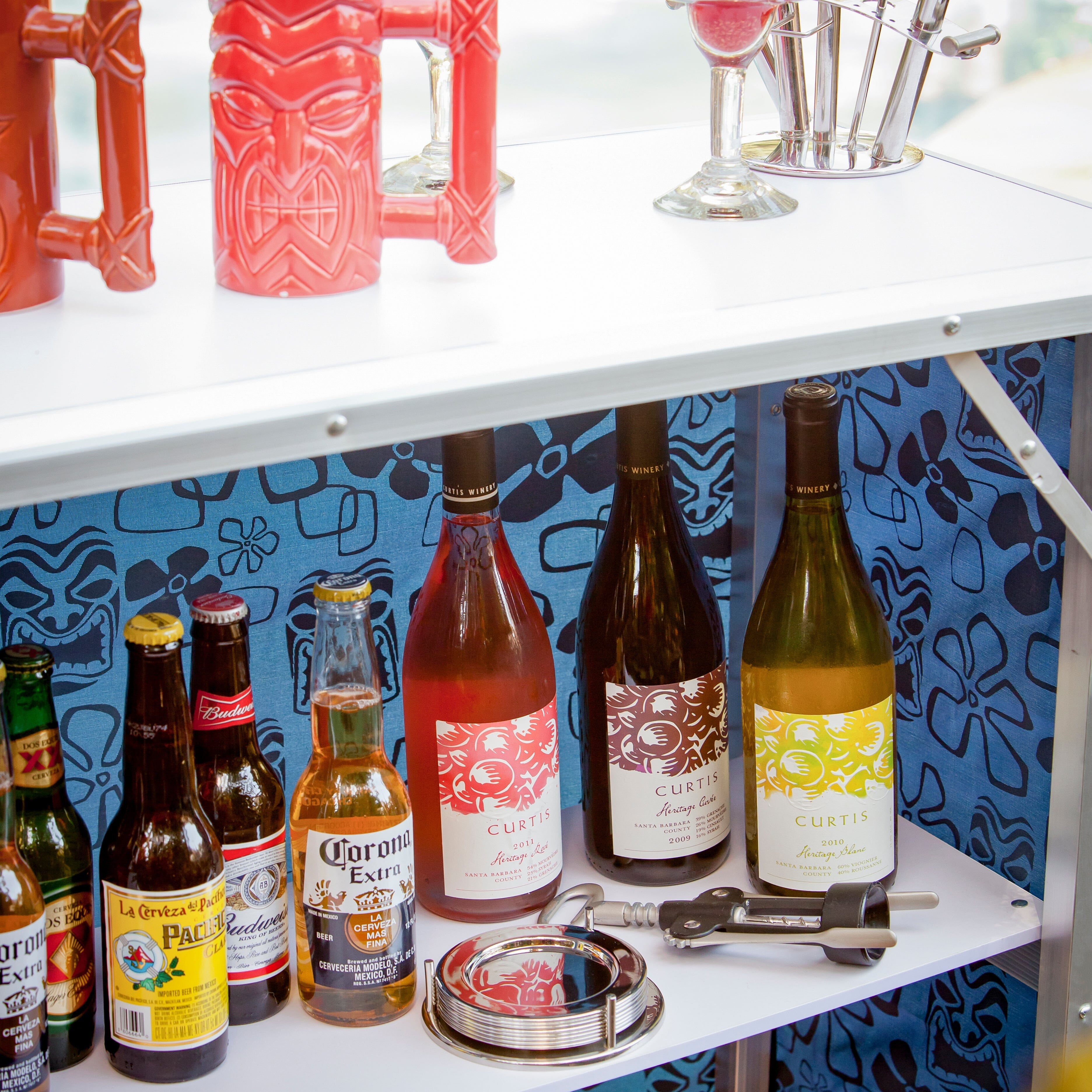 a shelf with a variety of bottles and glasses