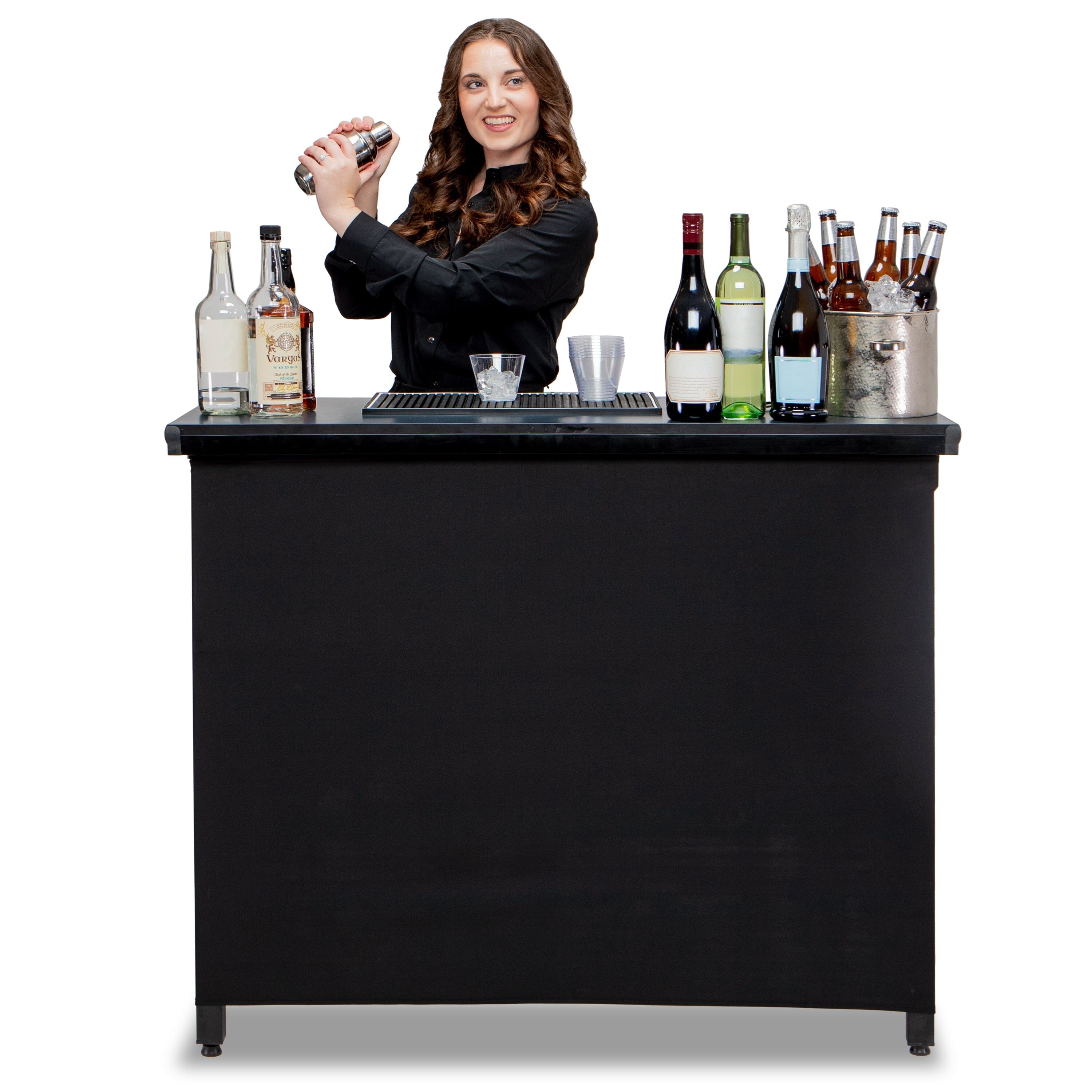 a woman behind a bar with bottles of alcohol