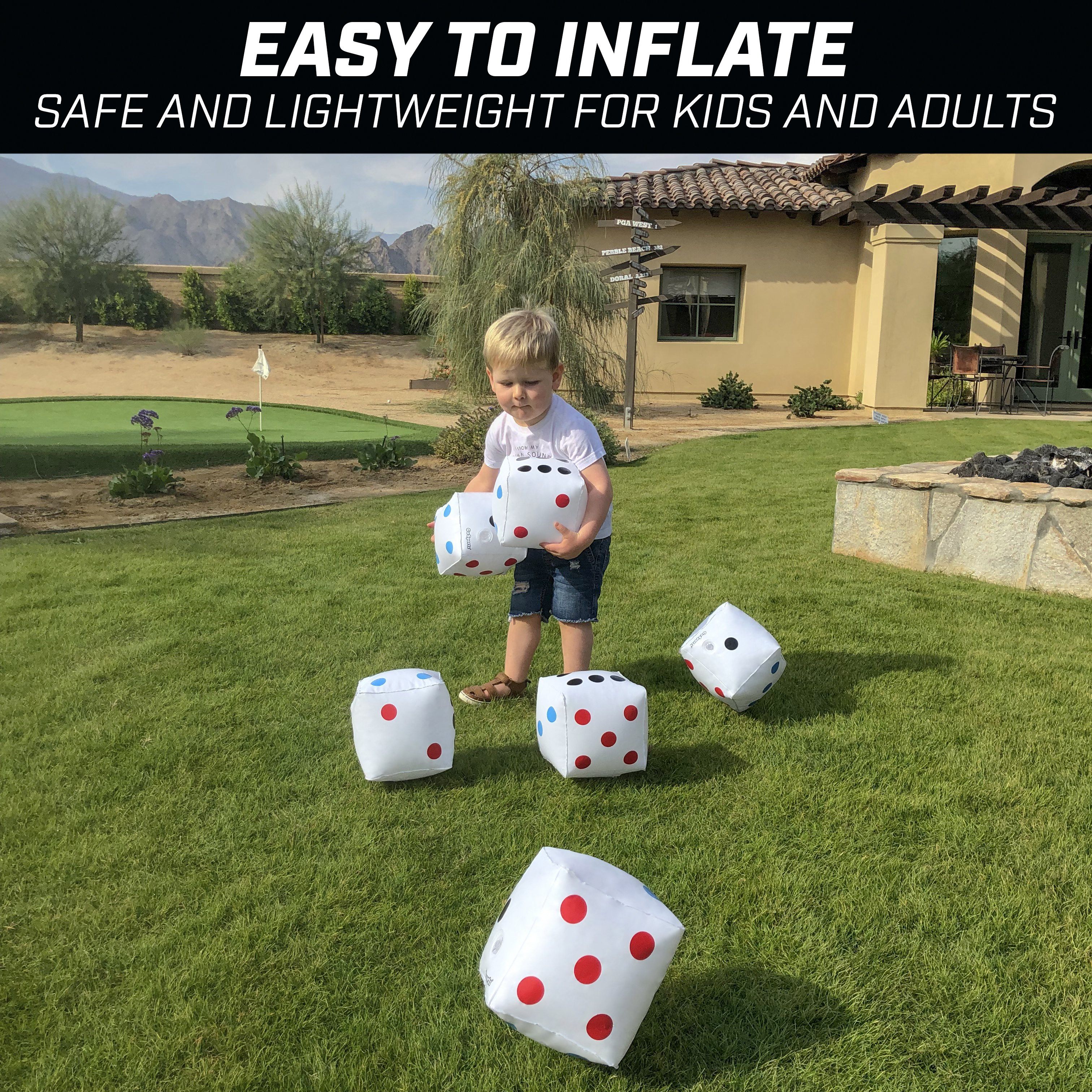 a little boy playing with some white and red polka dots