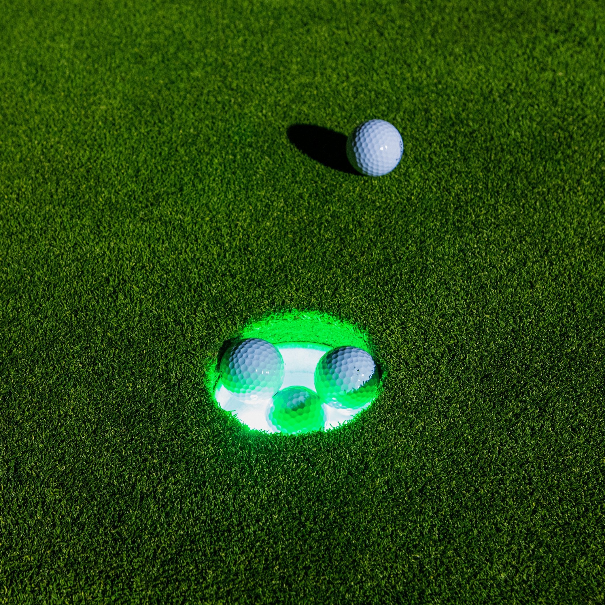 a golf ball and a golf club marker on a green field