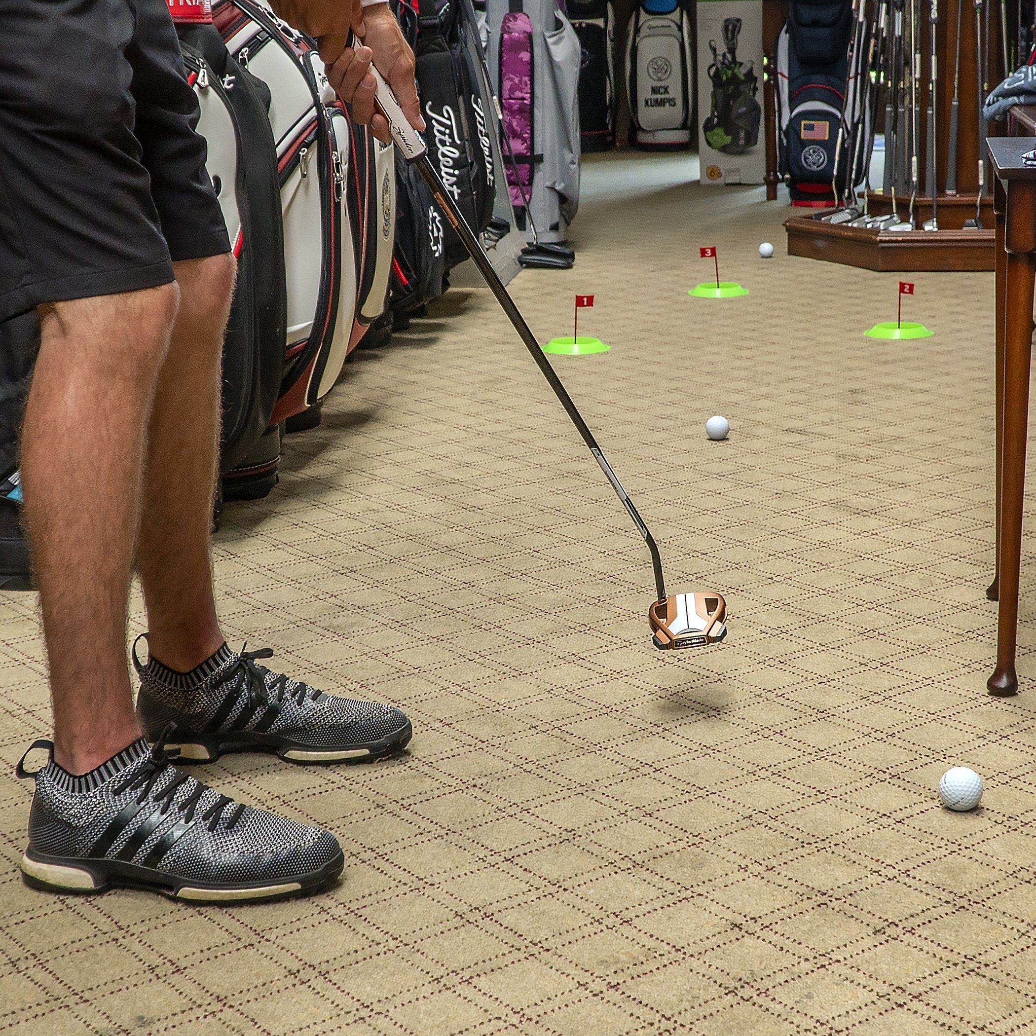 a man is playing golf in a room