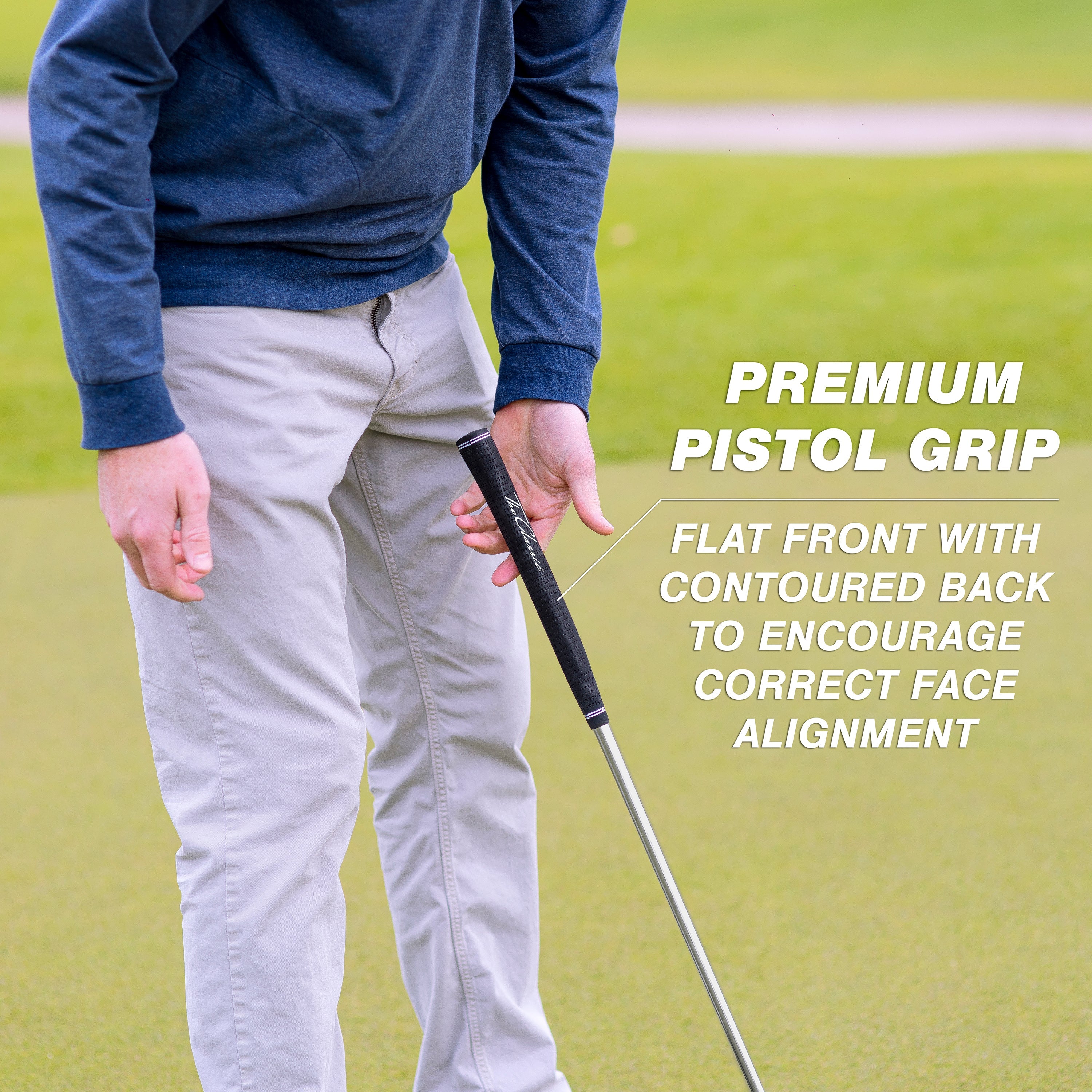 a man holding a golf club on a green field