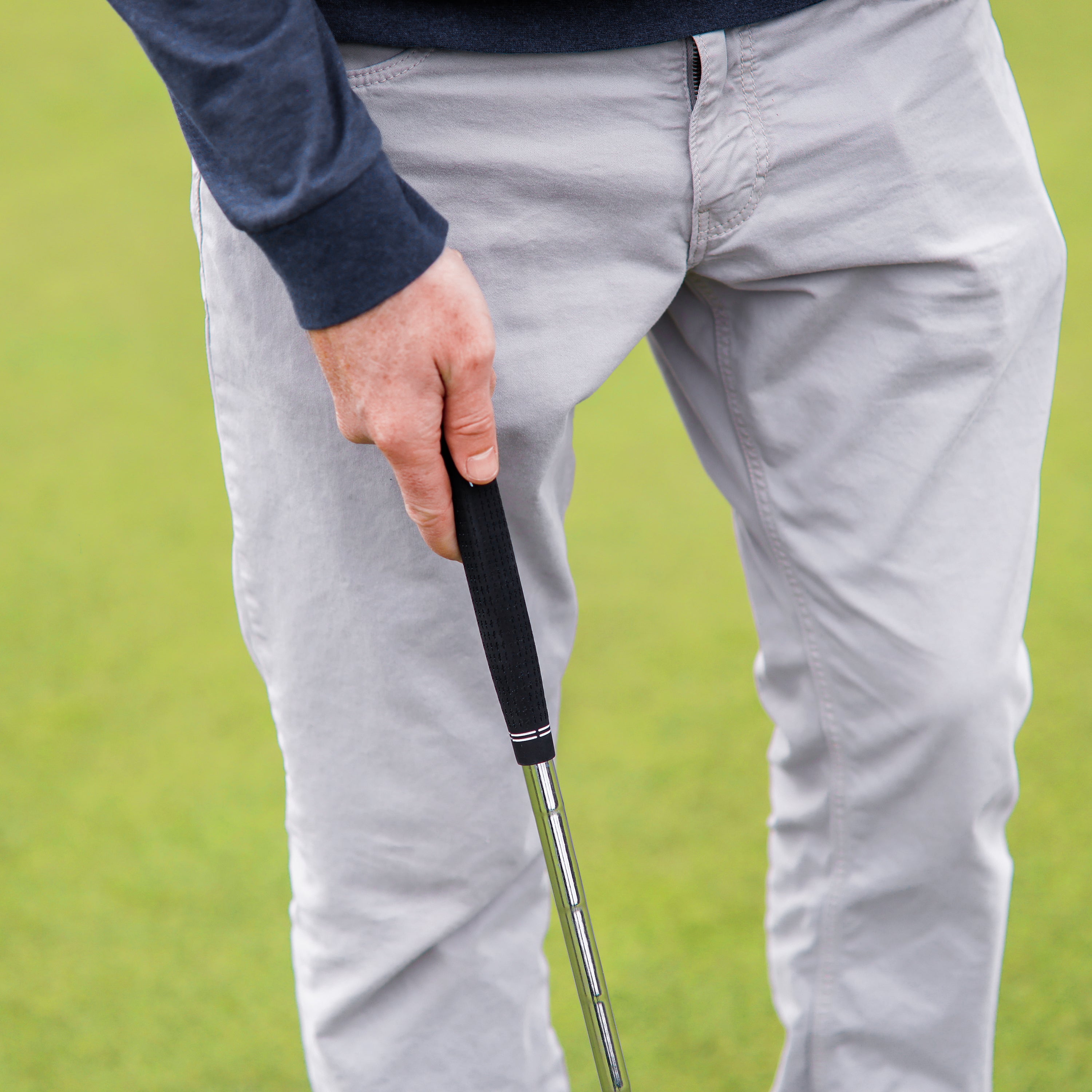 a man holding a golf club in his hand