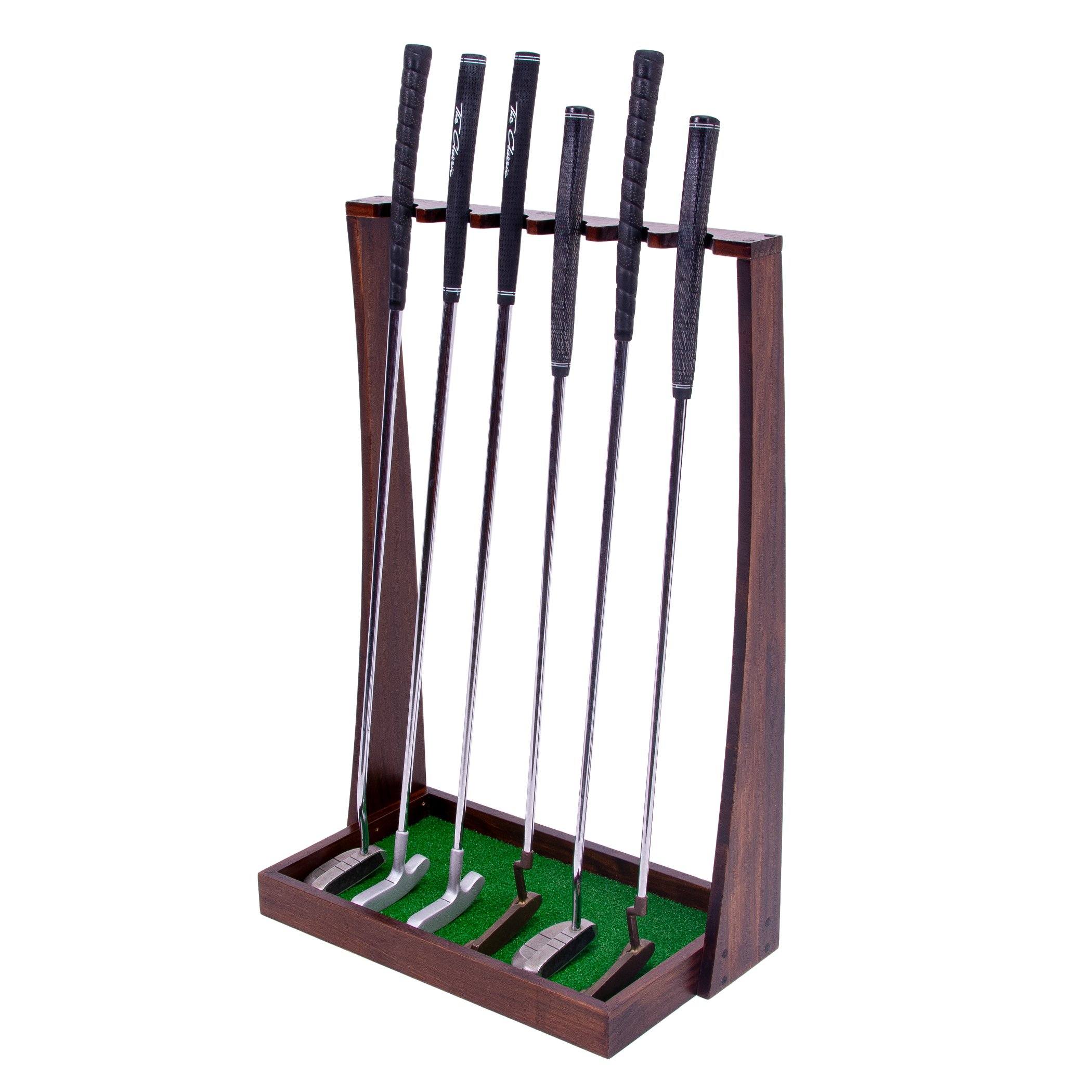 a wooden golf set with four clubs and a green ball