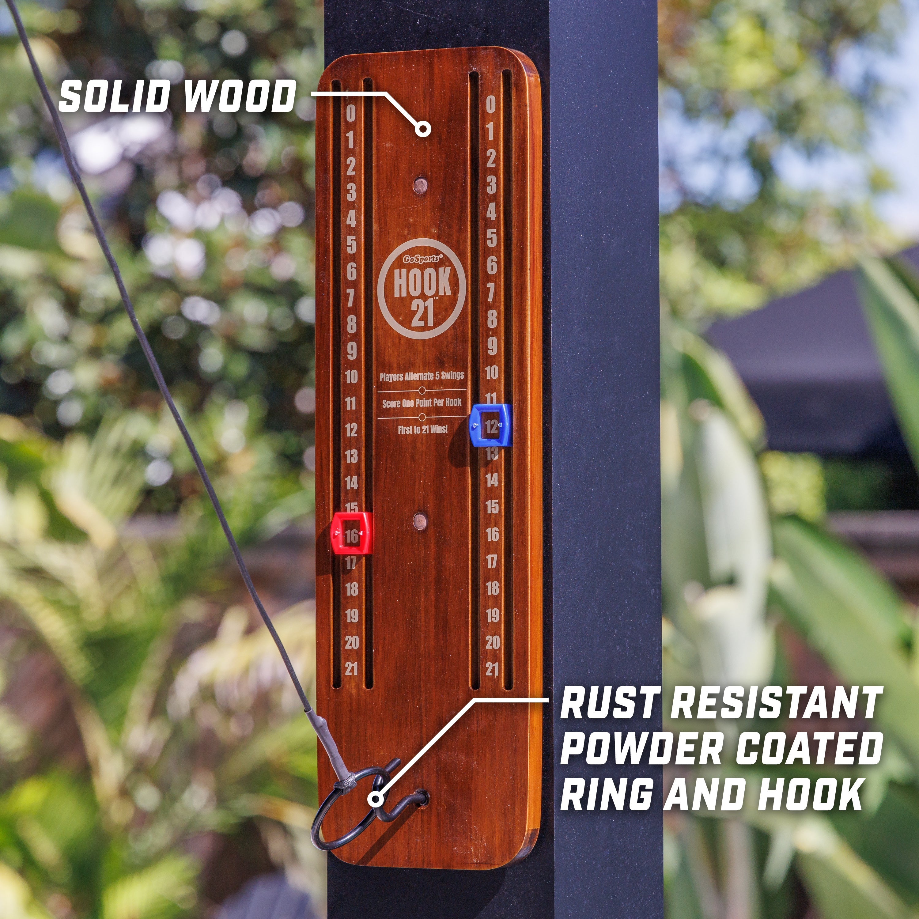 a wooden clock with a red knob and a blue arrow