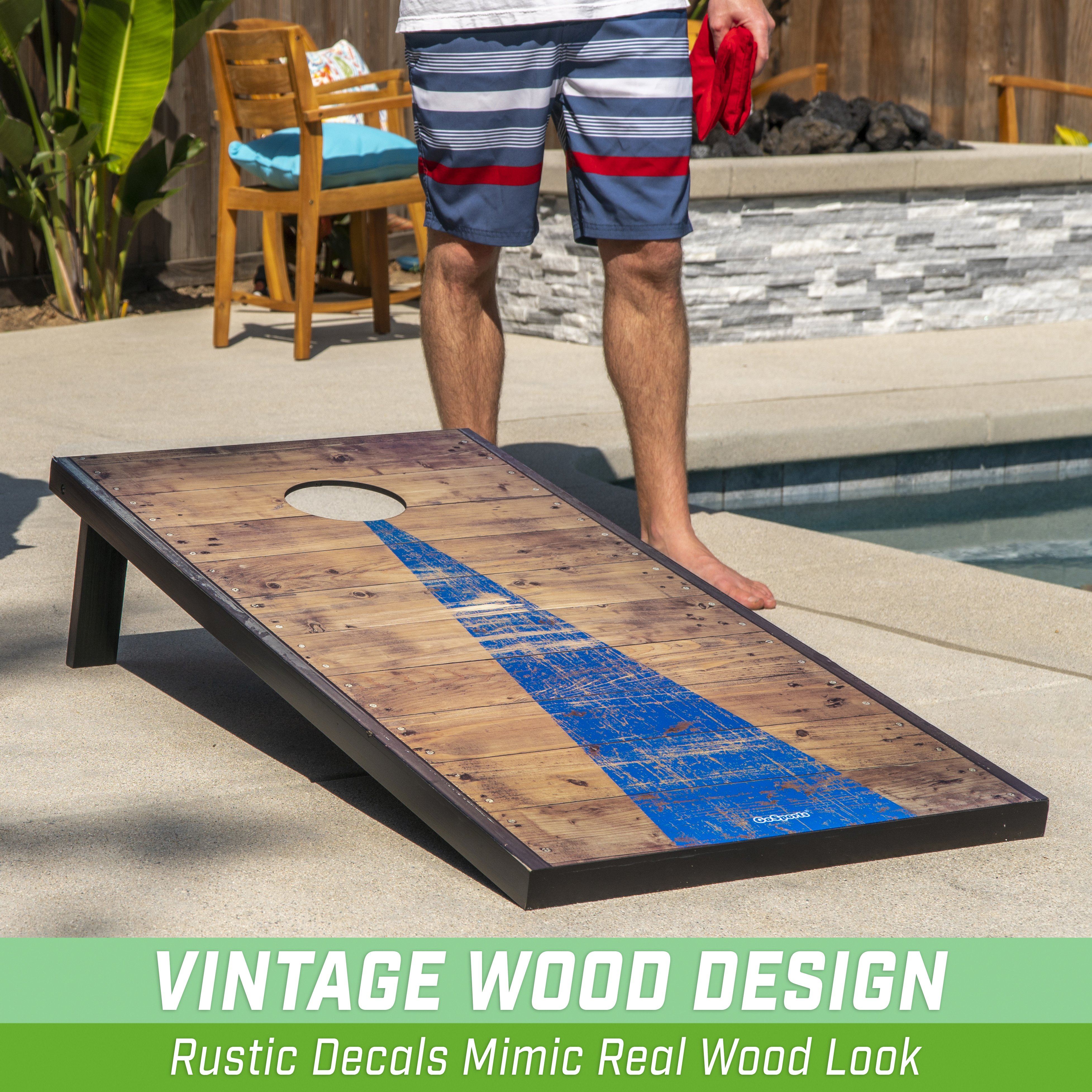 a man standing next to a pool with a wooden board
