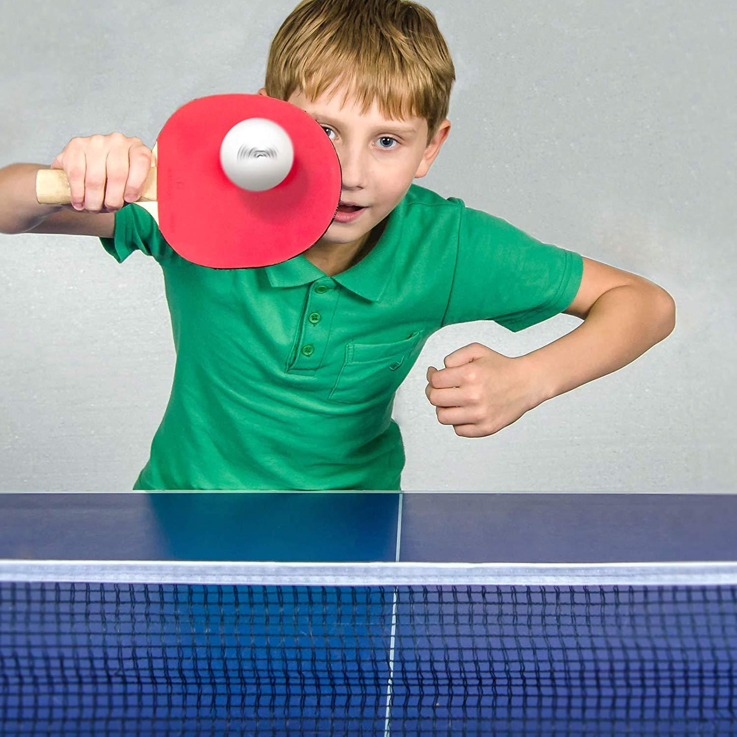 a boy playing table tennis