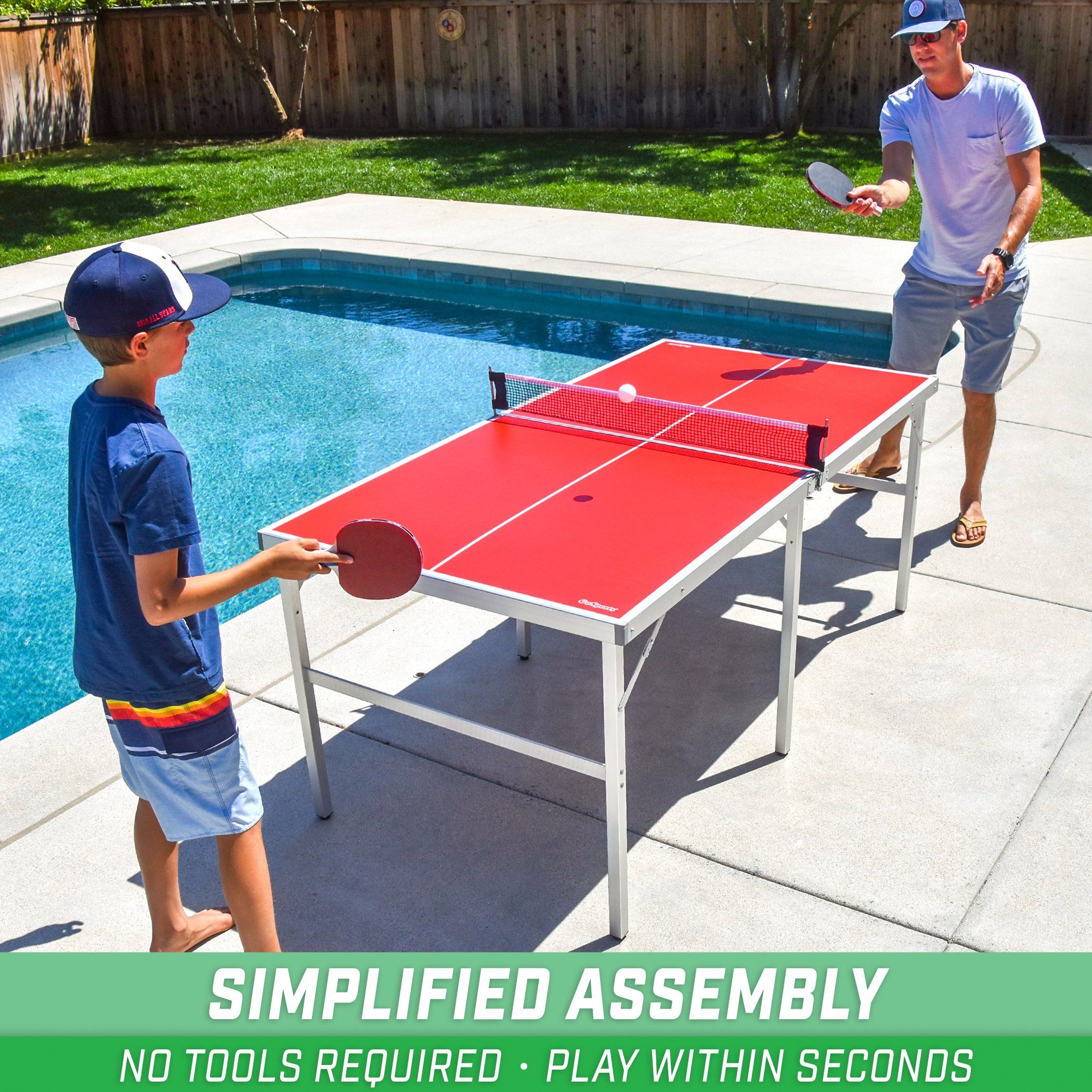 two boys playing table tennis in a backyard pool