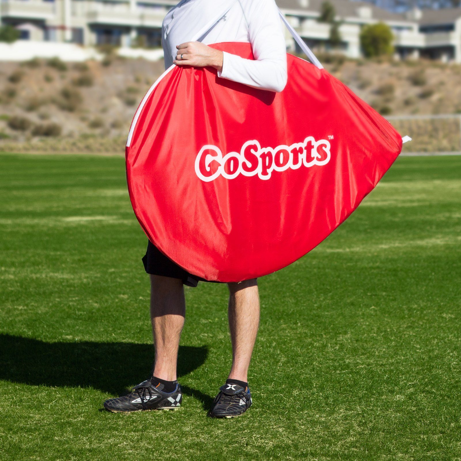 a man holding a red bag with the word coors on it