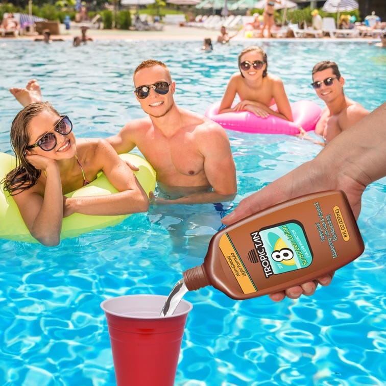 a man and woman in a pool with a bottle of suntant