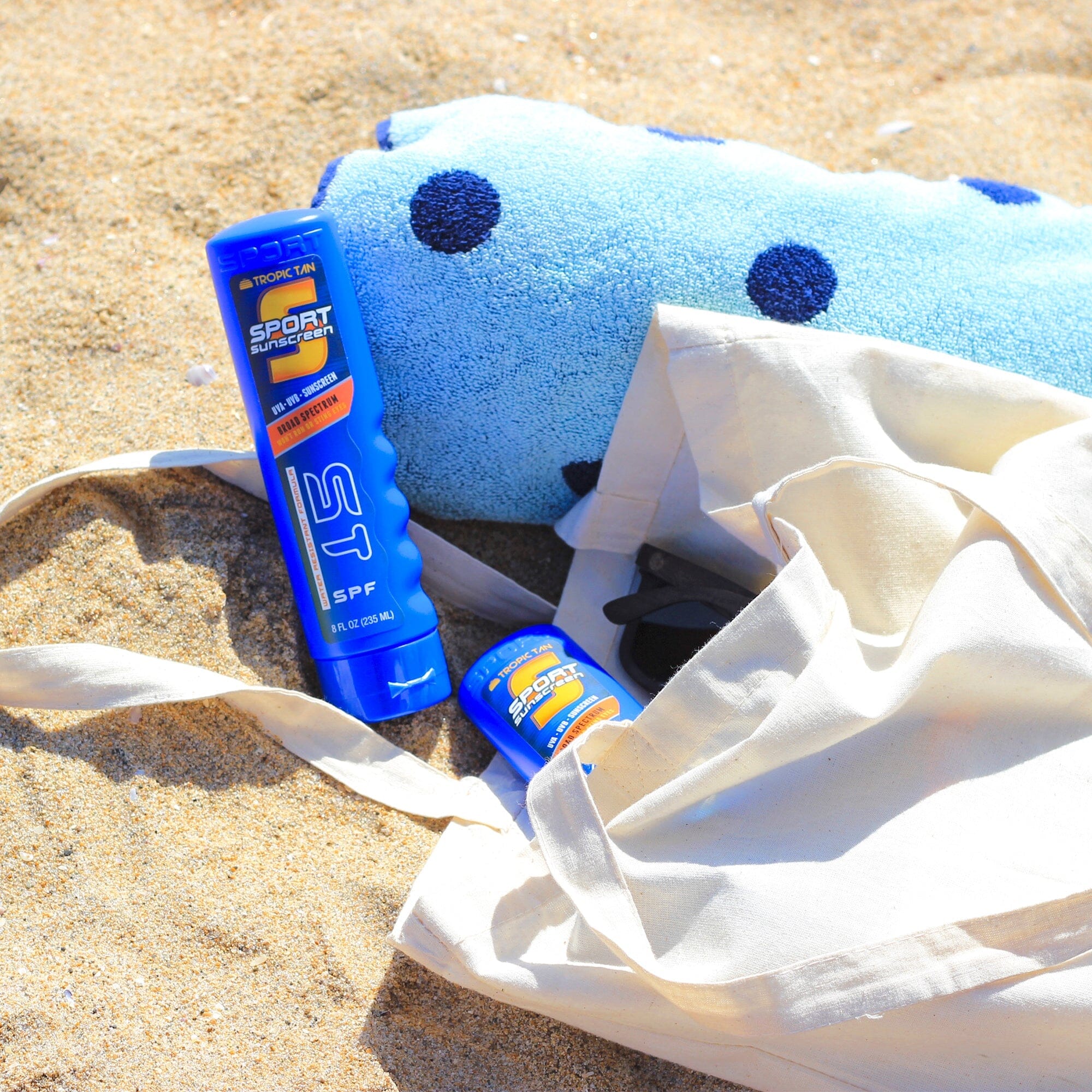 a towel, toothpas, and toothpas on the beach