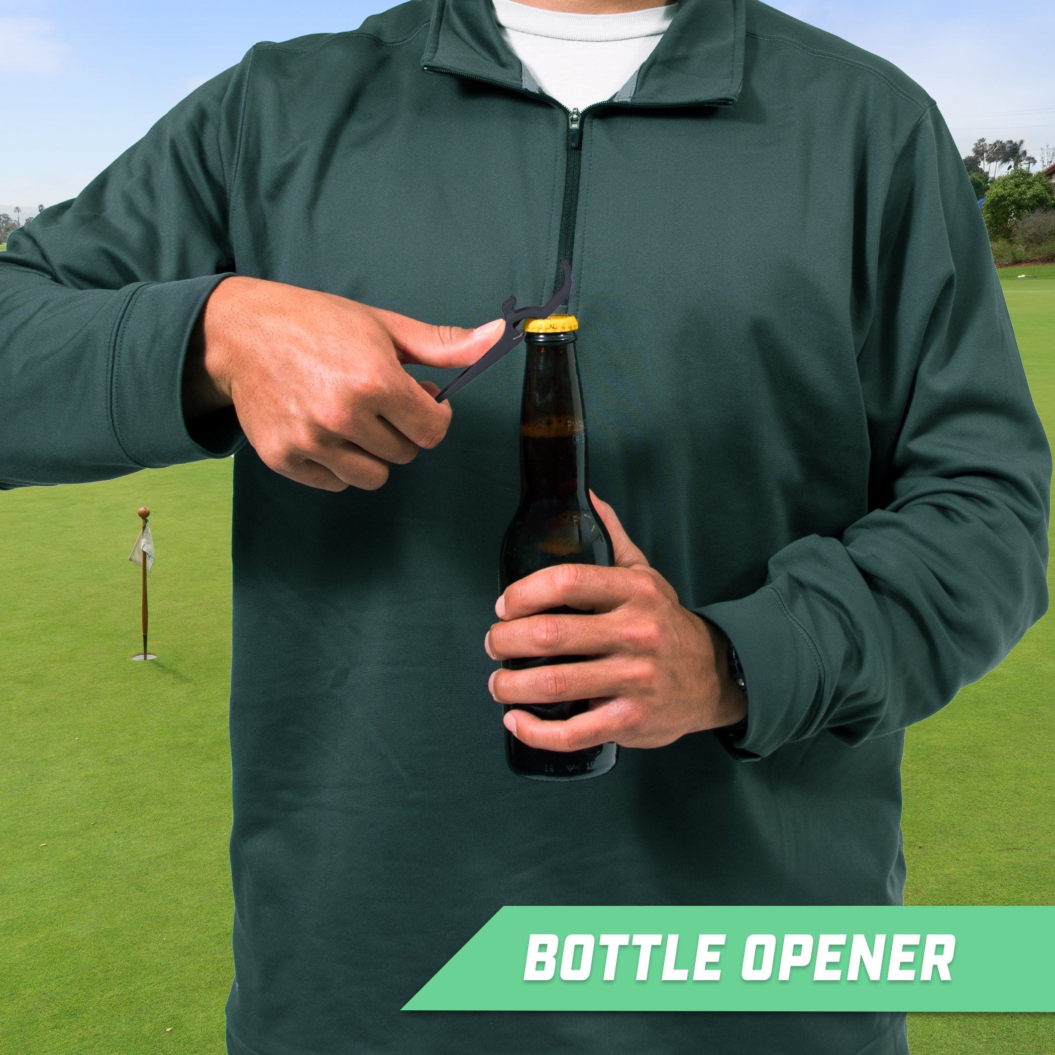 a man holding a bottle of beer on a golf course