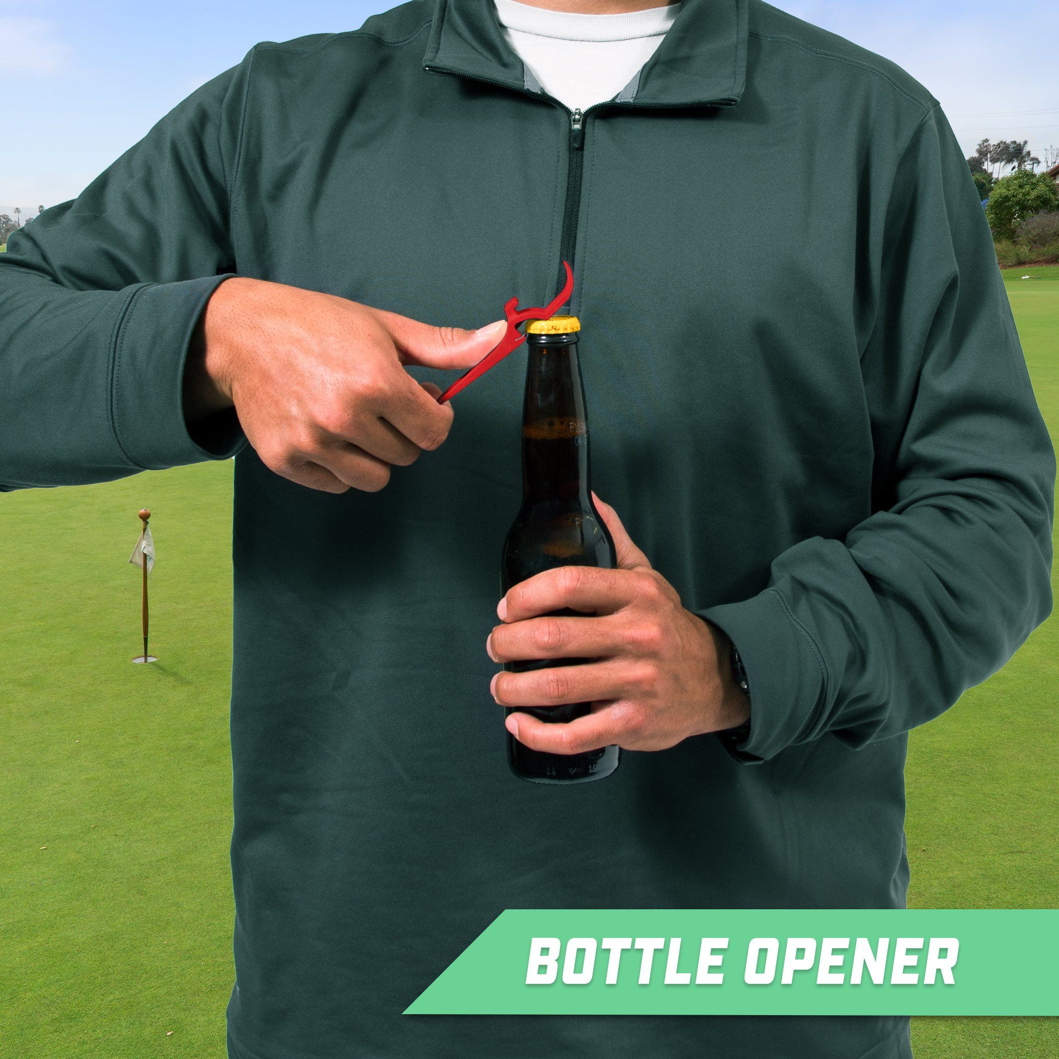 a man holding a bottle of beer on a golf course