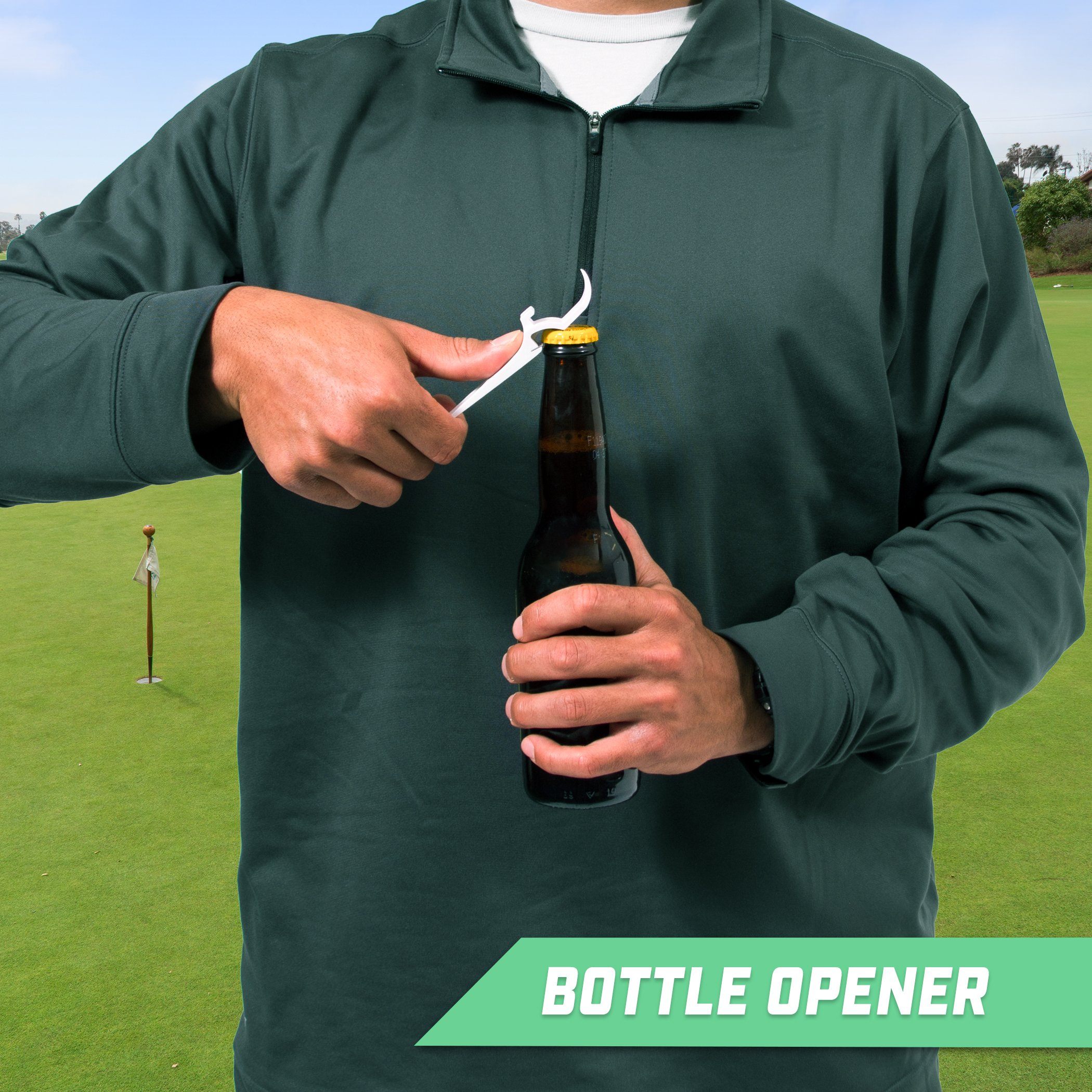 a man holding a bottle of beer on a golf course