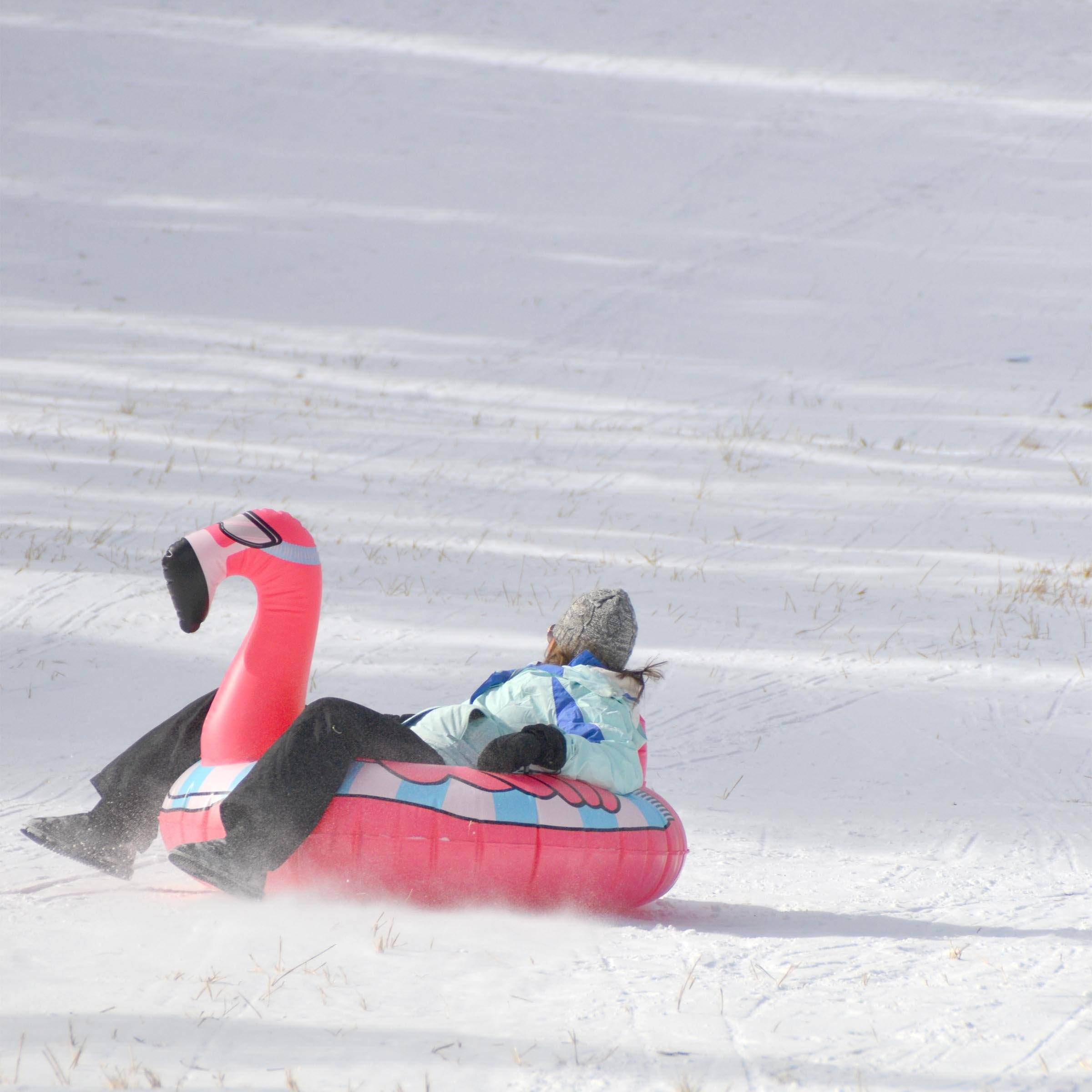 a person is sled down a hill