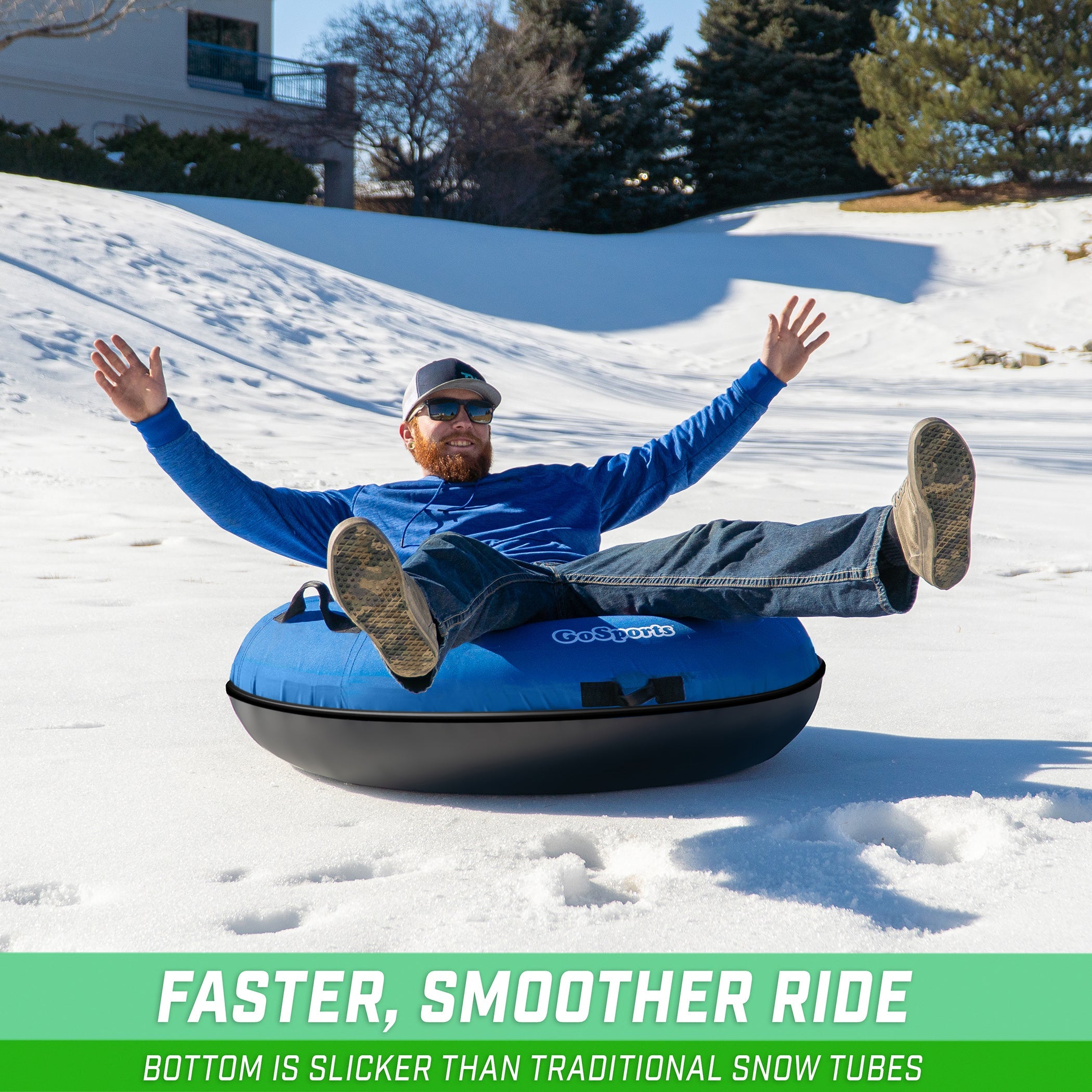 a man is sitting on a tube in the snow