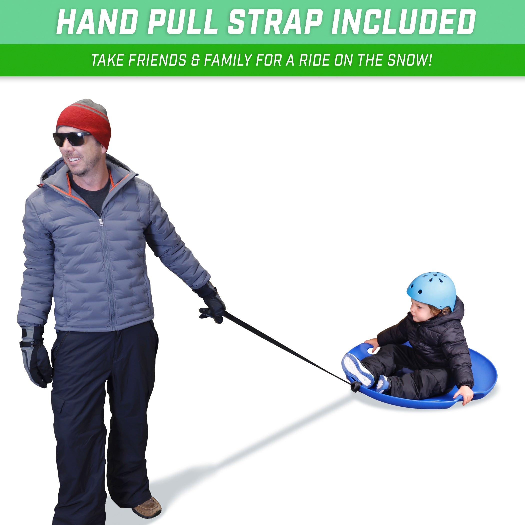 man pulling from a long handle a child with snow gear blue helmet on top of a blue saucer