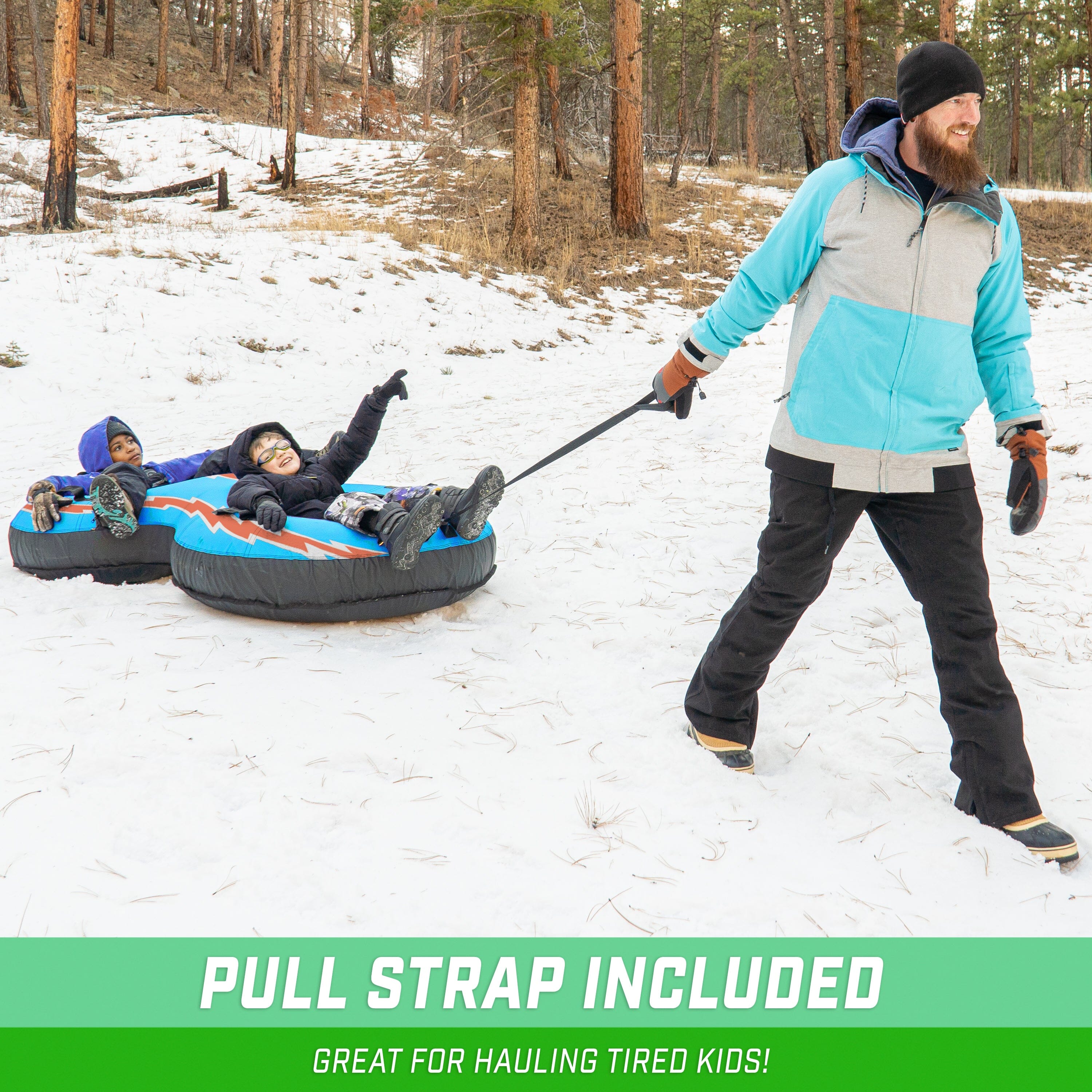man pulling double snow tube with two children on it