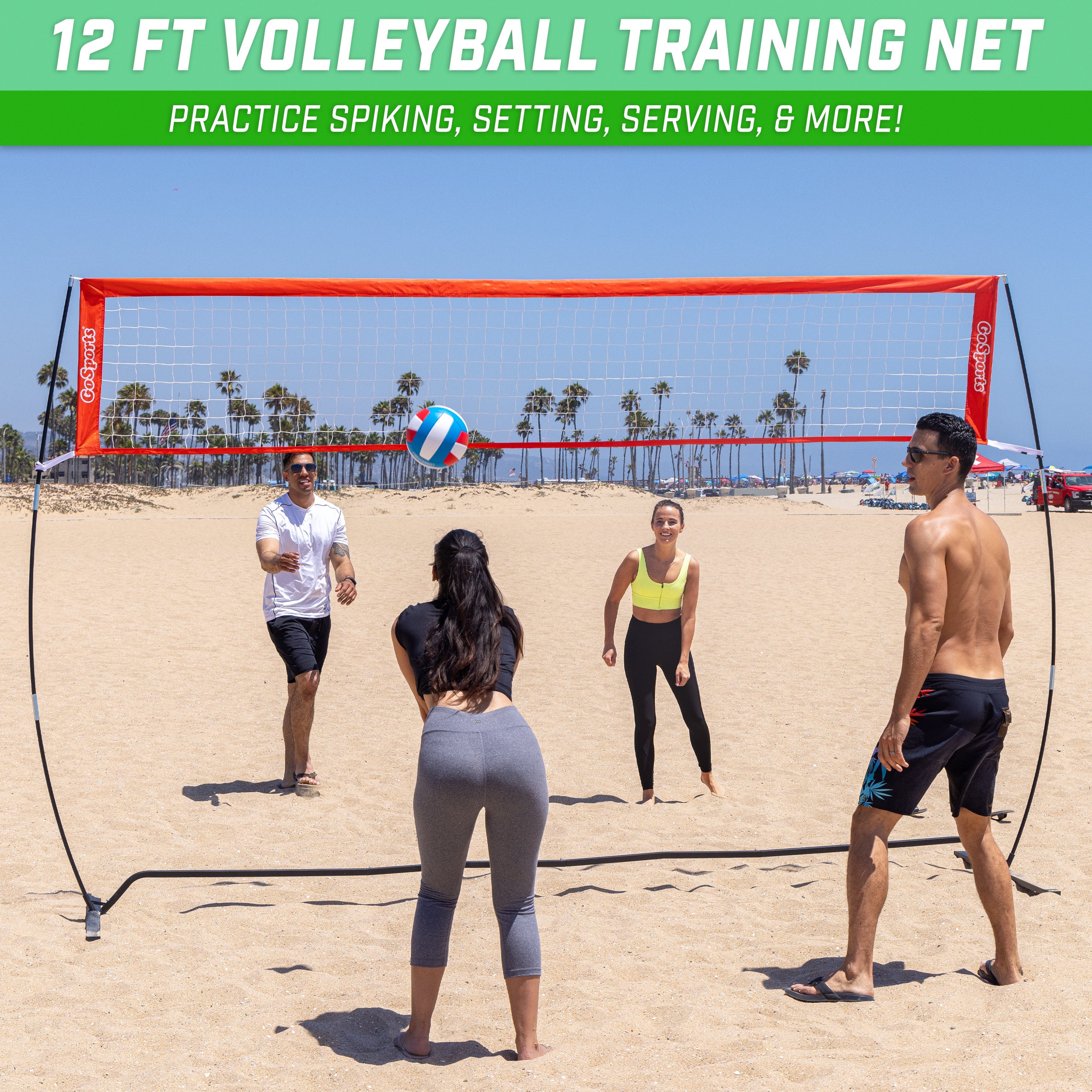 a group of people playing volleyball on a beach