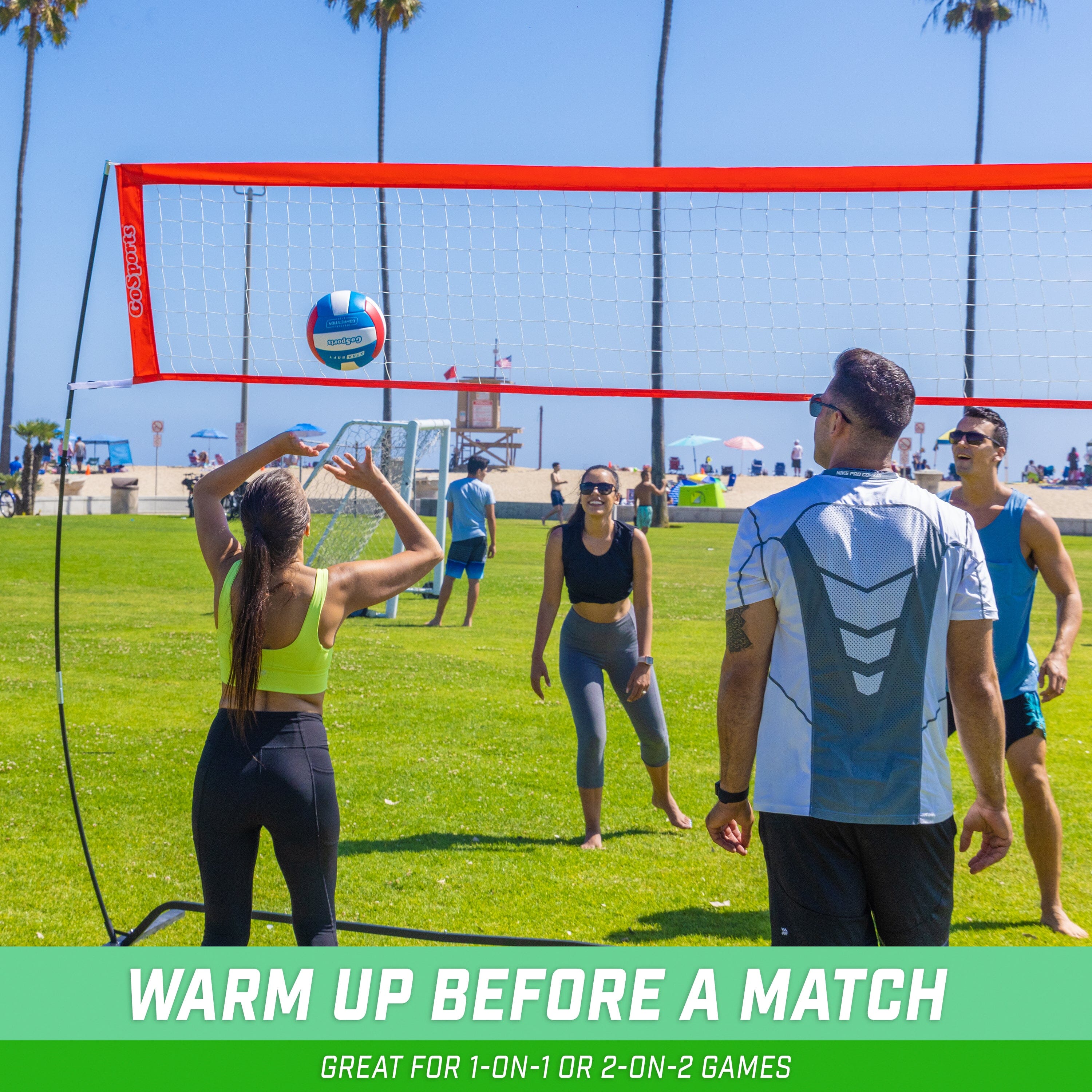 a group of people playing volleyball on a field