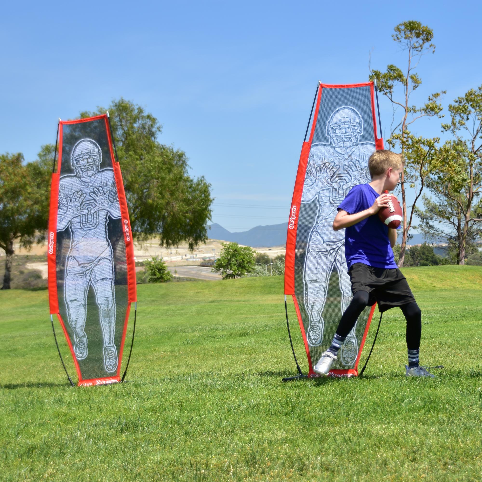 a boy is playing with a kite