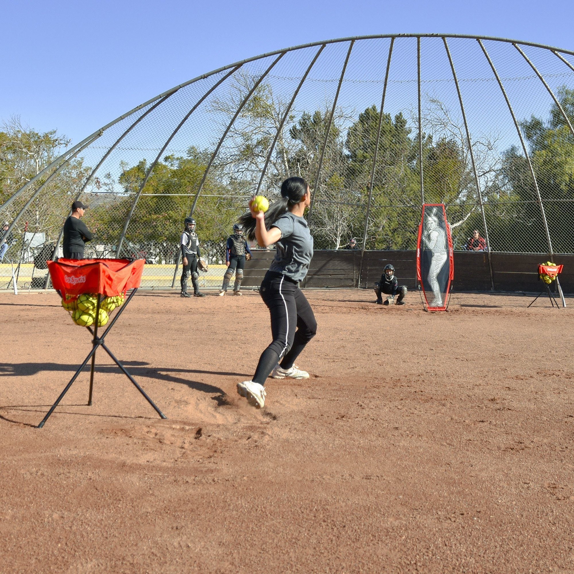 a woman is swinging a bat at a baseball game