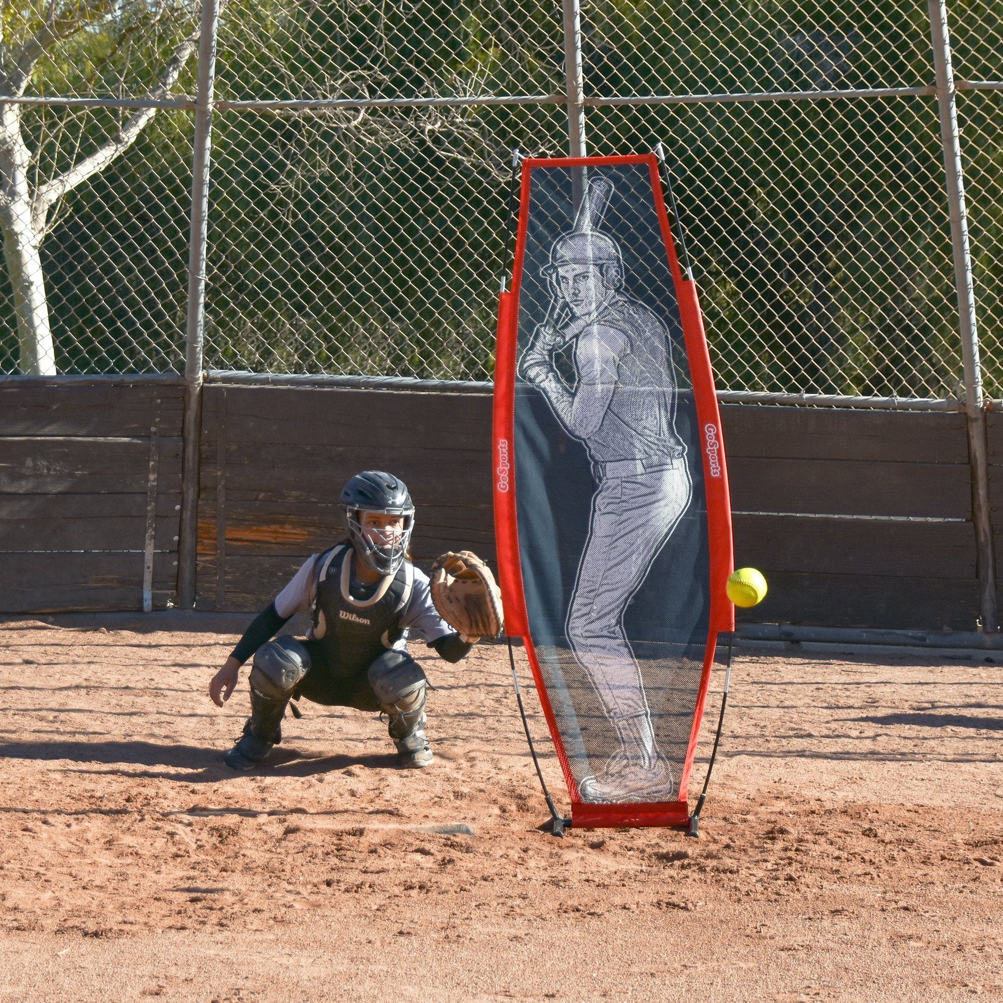 a man is playing baseball on a dirt field