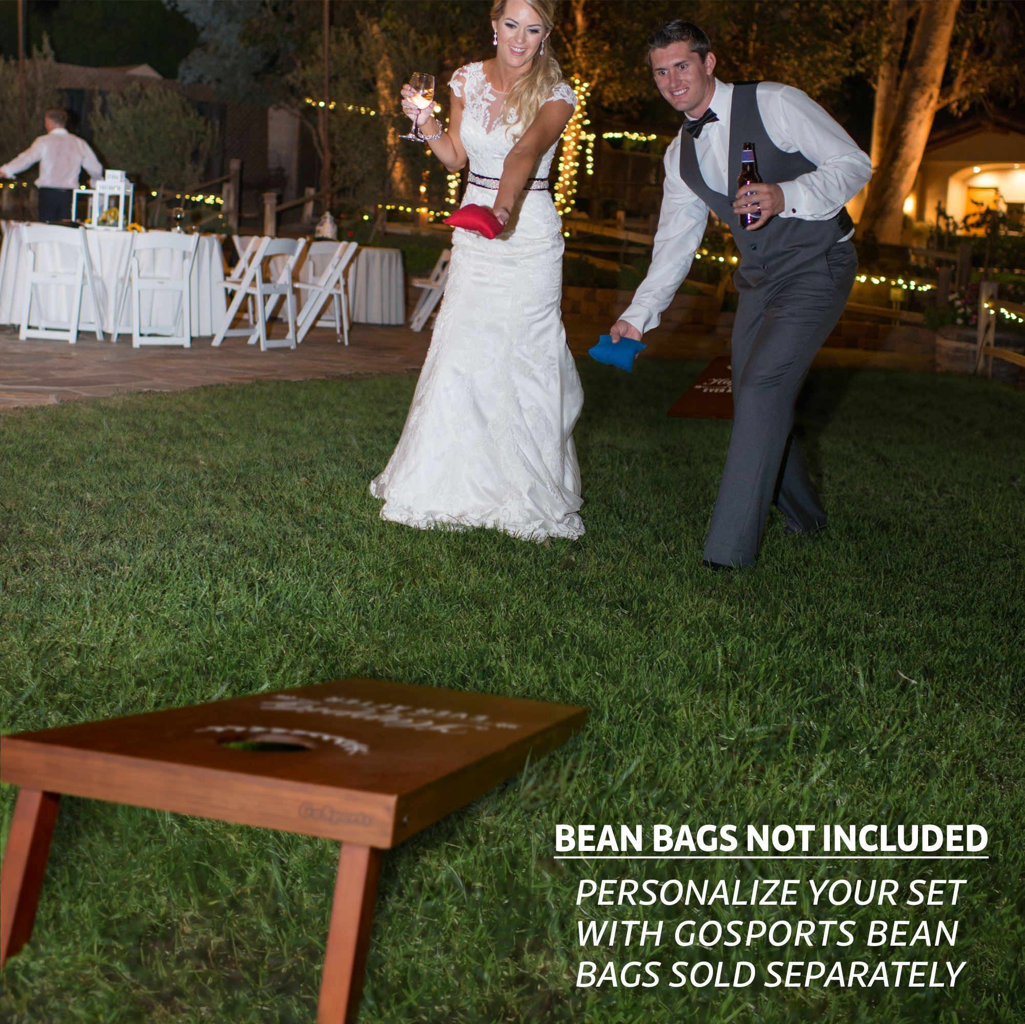 a bride and groom are dancing in the grass