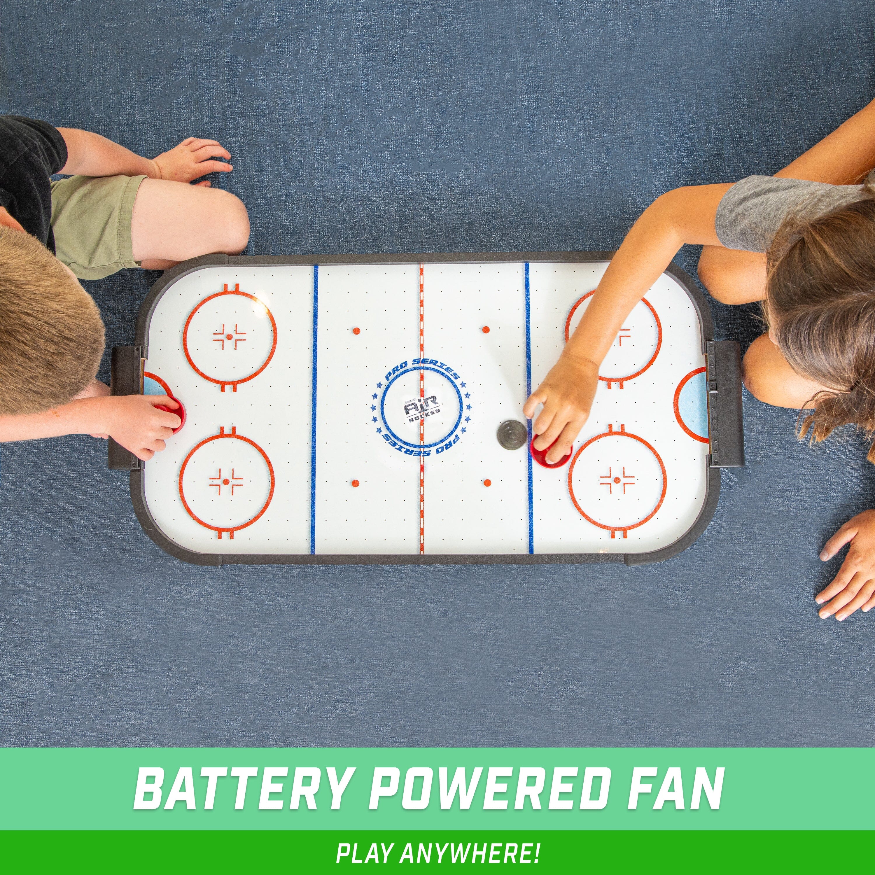 two boys playing a game of hockey on a table