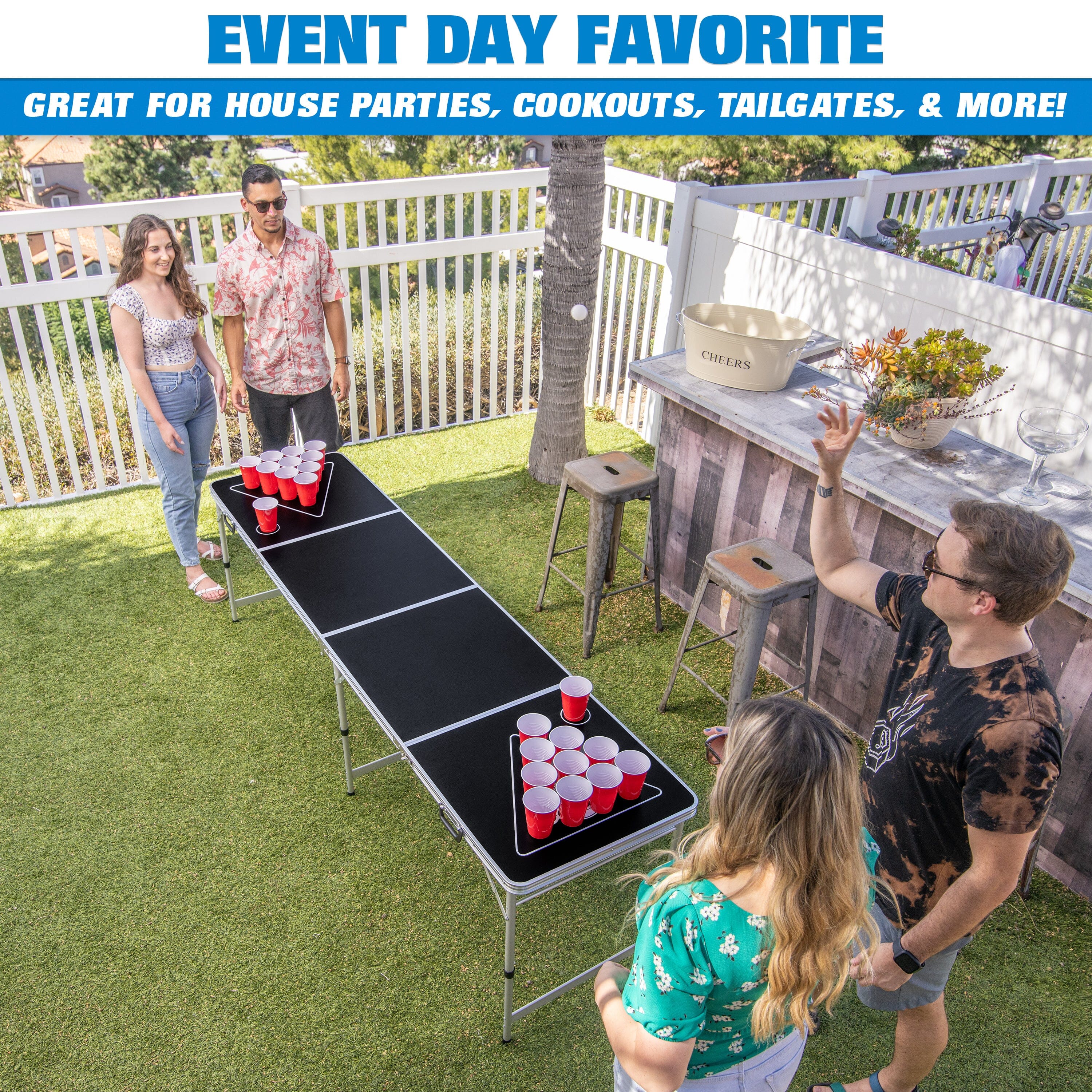 a group of people playing a game of beer pong on a lawn