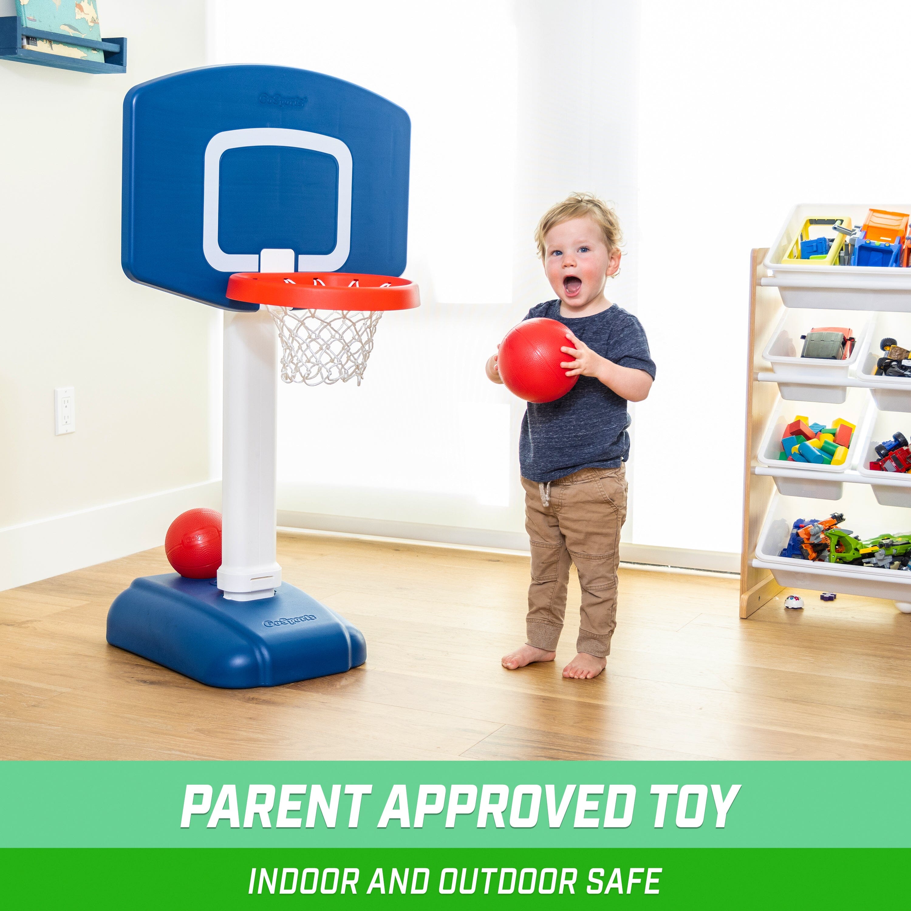 a young boy playing with a basketball hoop