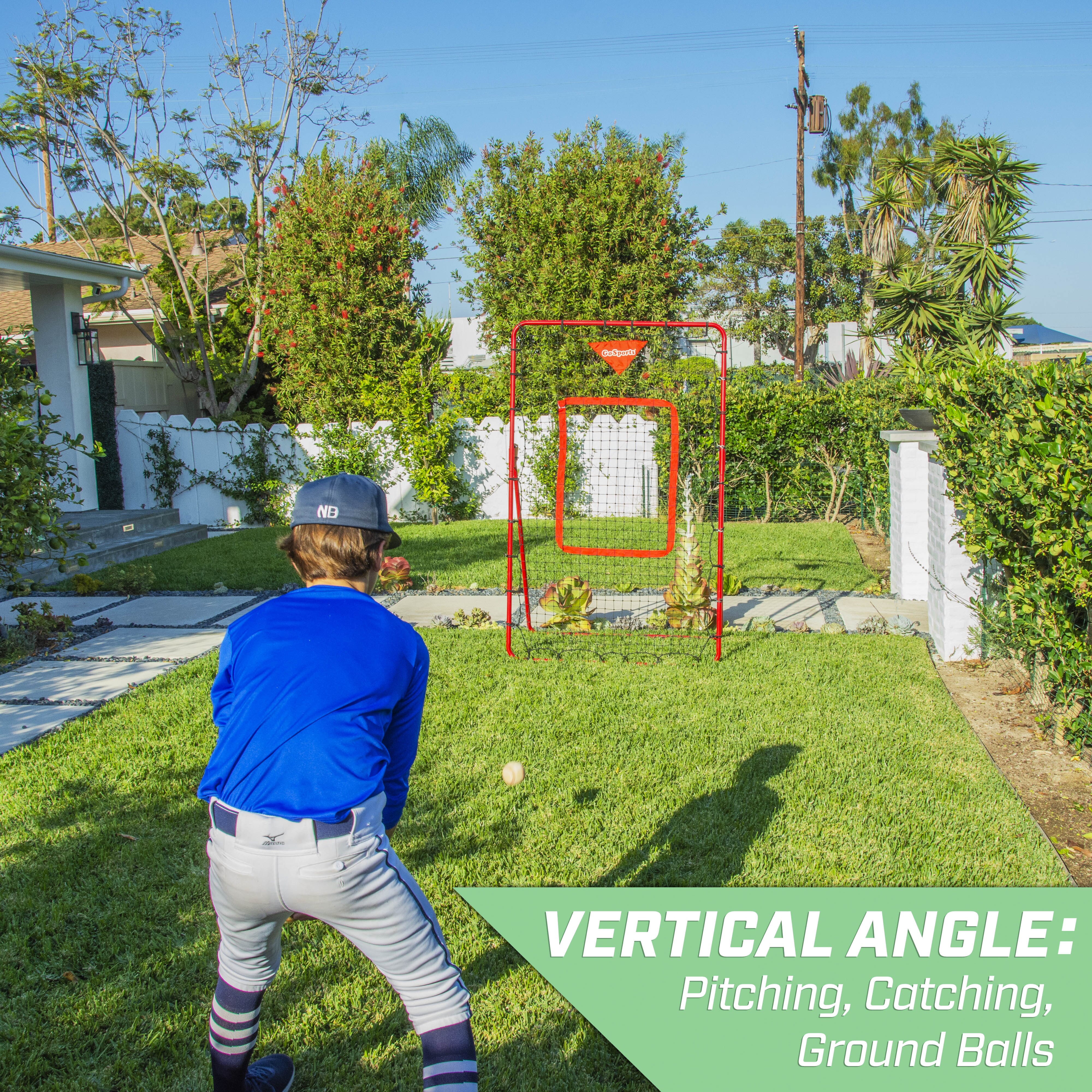 a man in a blue shirt and white pants swinging a baseball bat