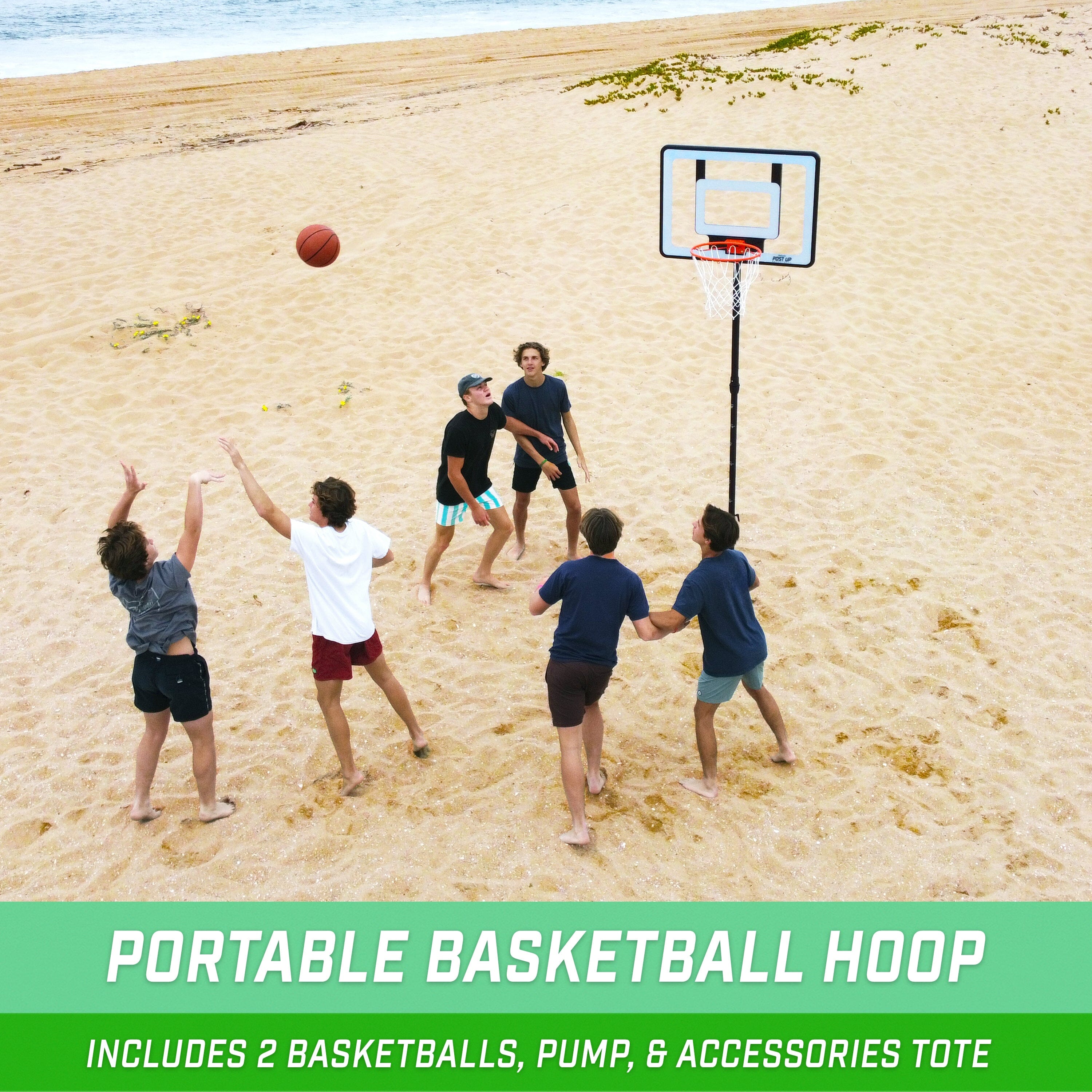 a group of kids playing basketball on the beach
