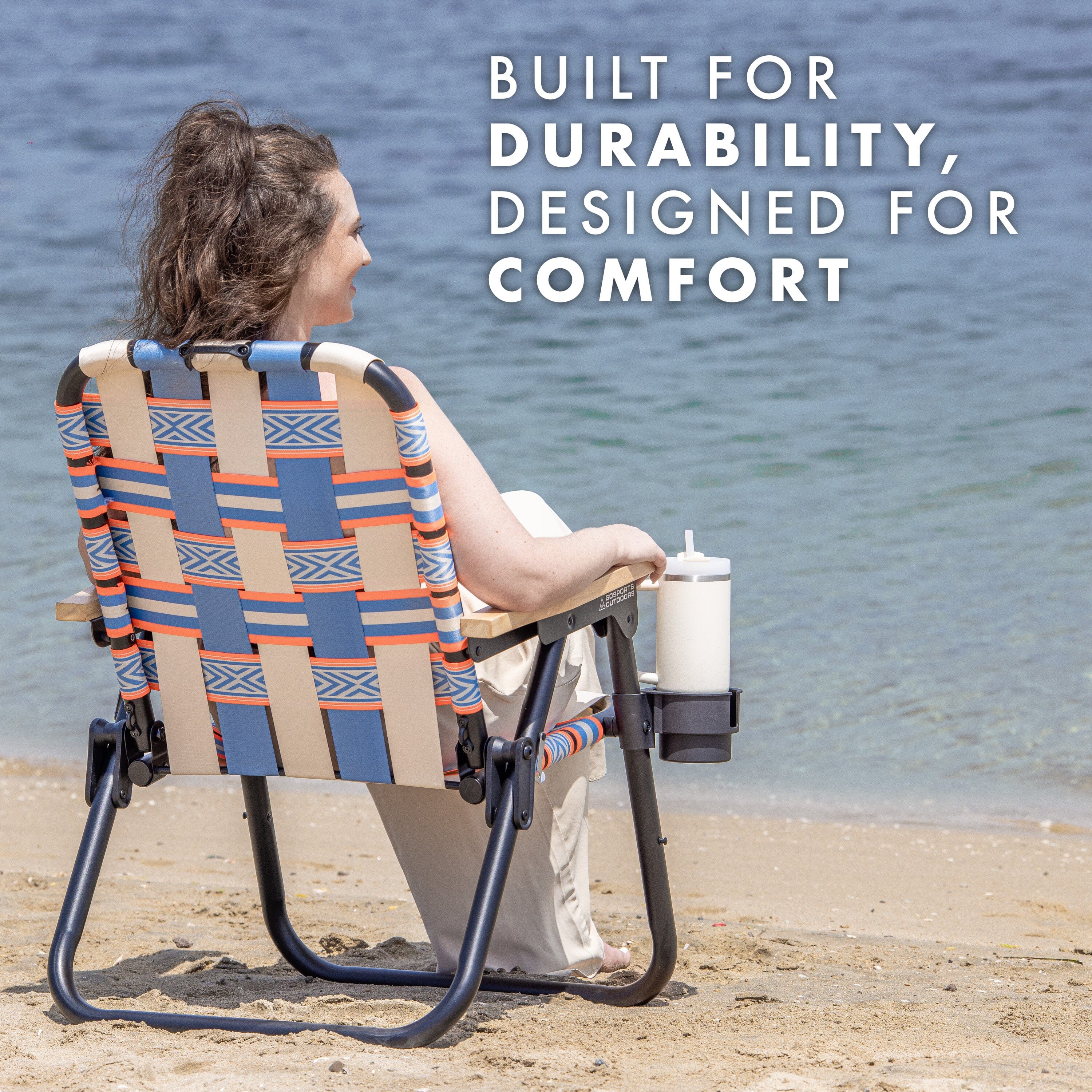 a woman sitting in a beach chair on the beach