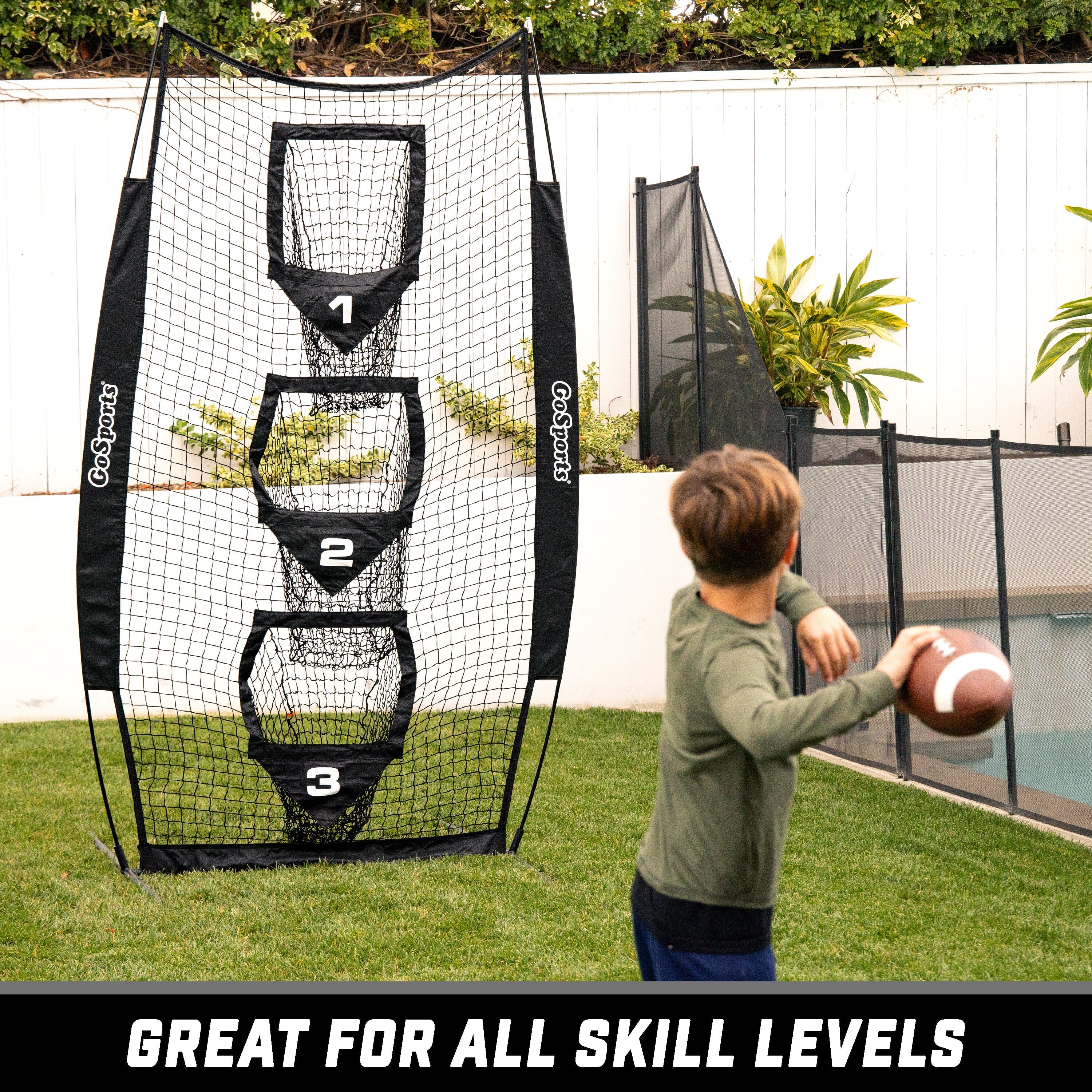 a young boy playing with a football ball