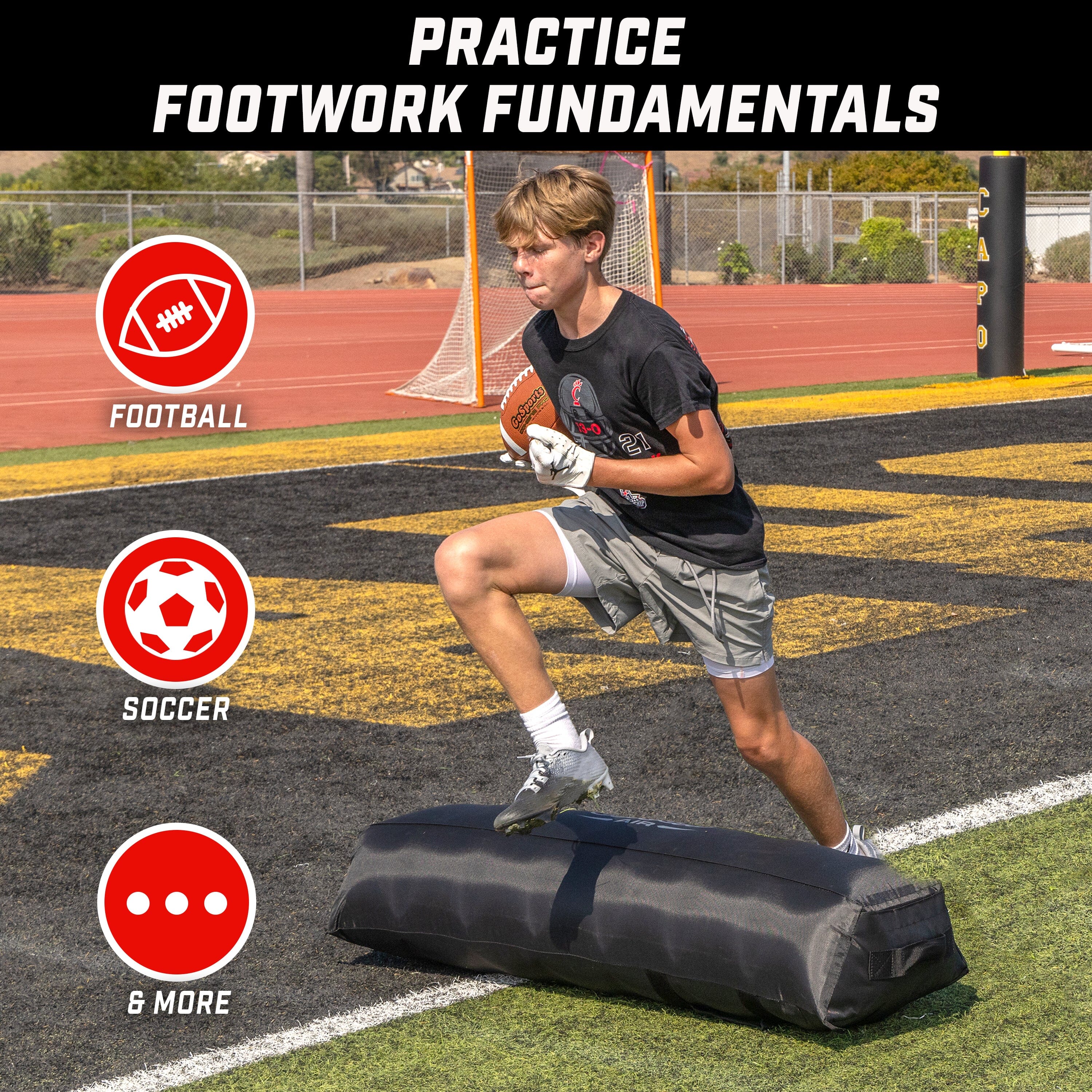 boy in football field jumping over black hurdle