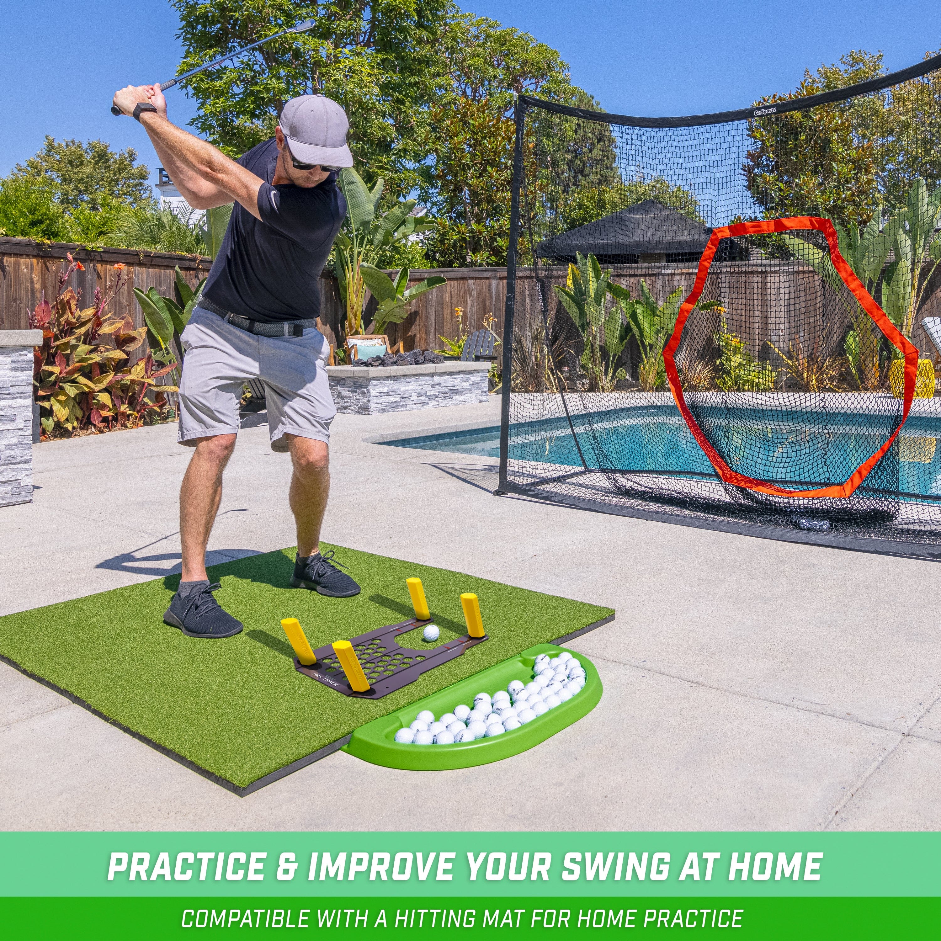 a man hitting golf balls on a putting mat