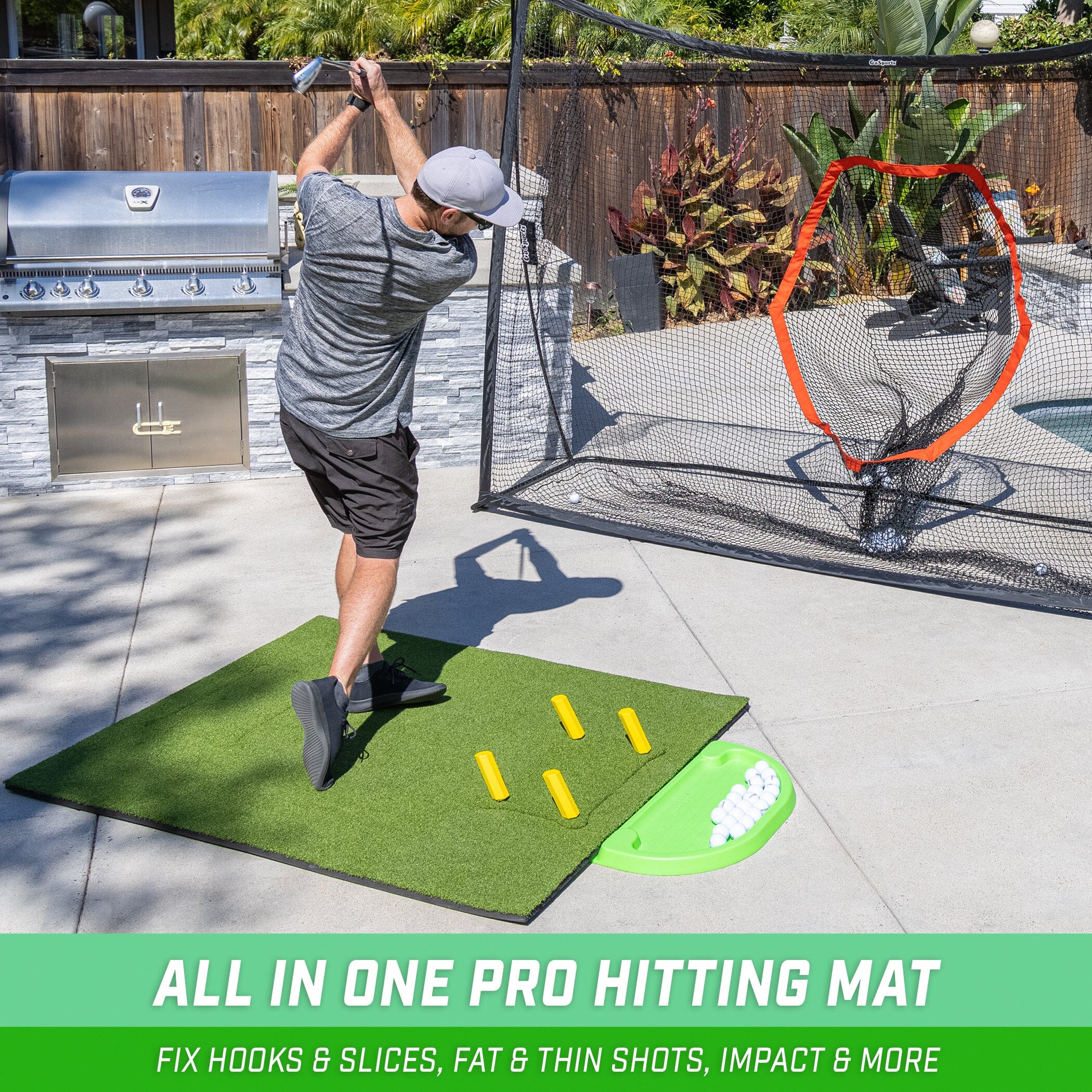 a man swinging a golf ball on a golf mat