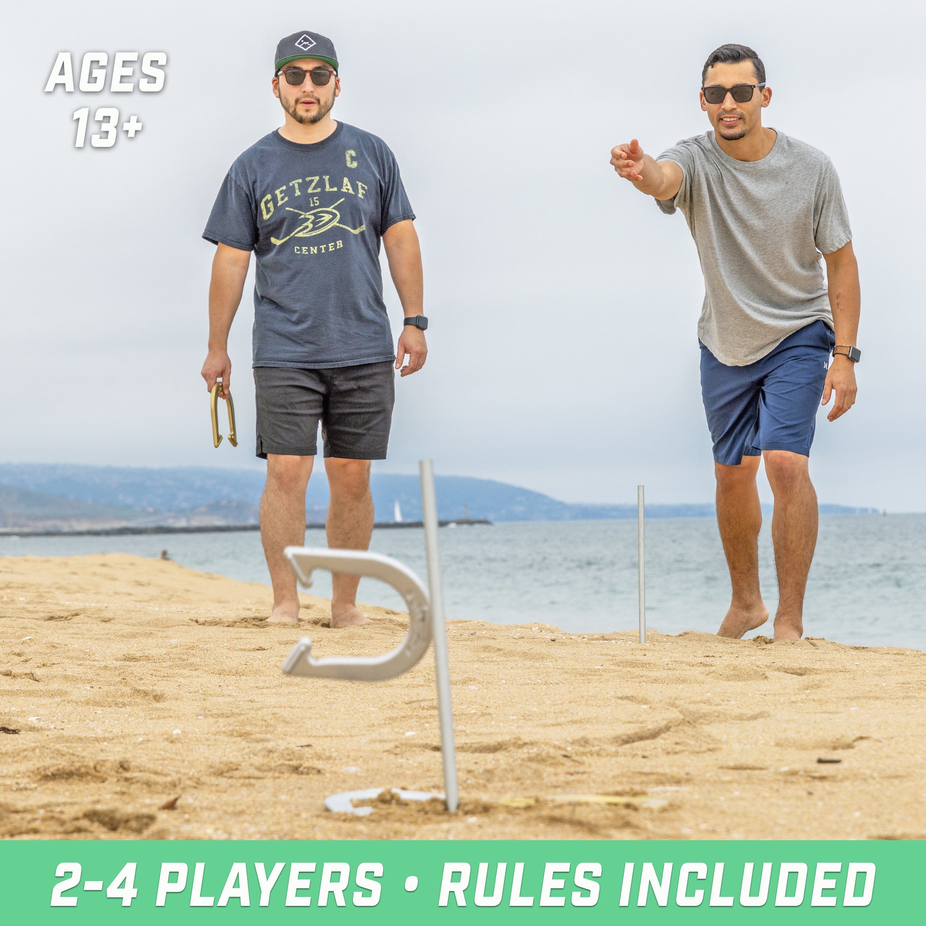 two men playing golf on the beach with a ball