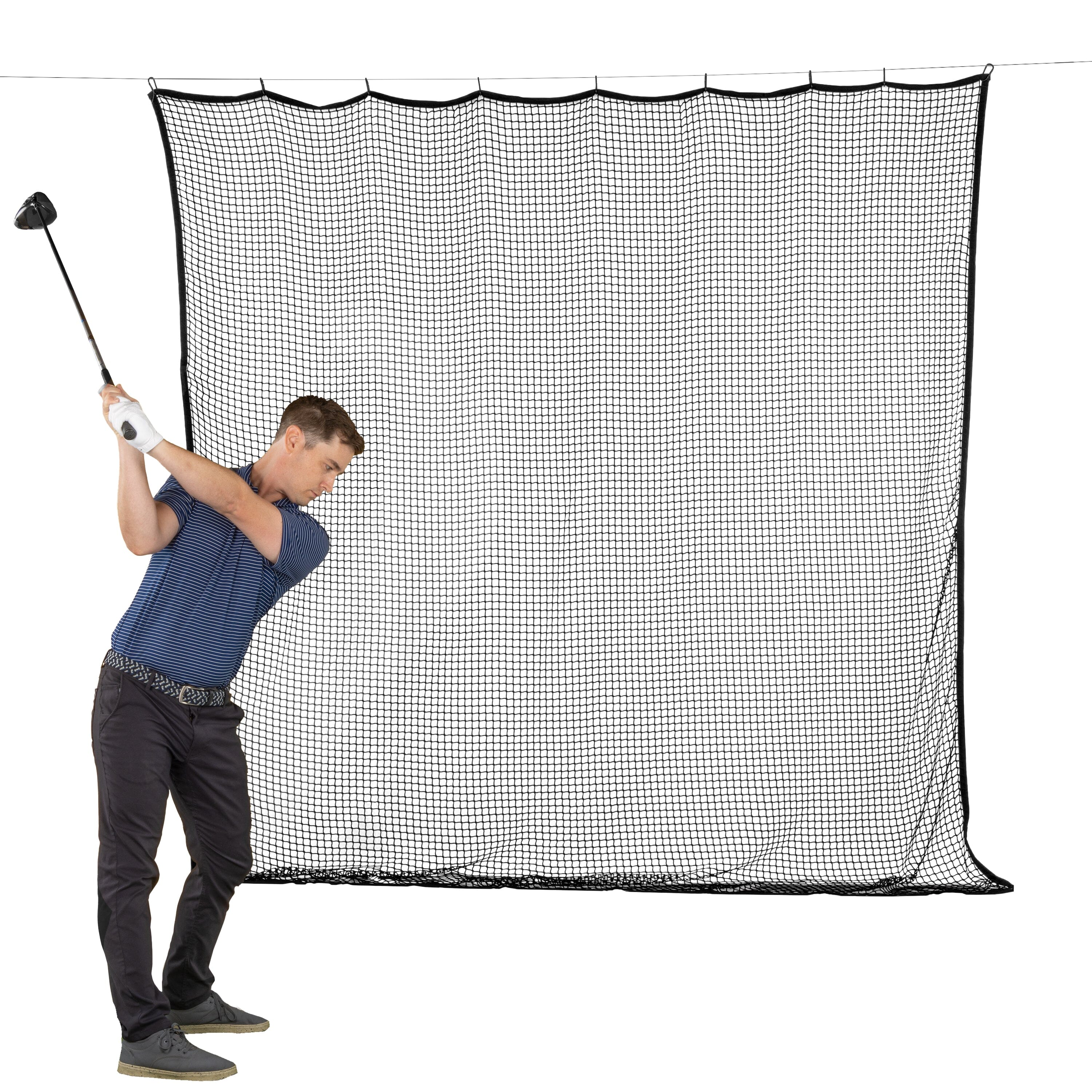 a man hitting a golf ball on a net