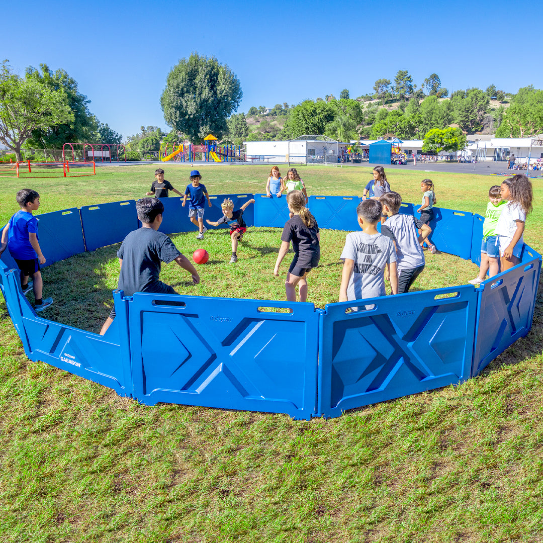 Children playing with a large blue playpen in an outdoor setting