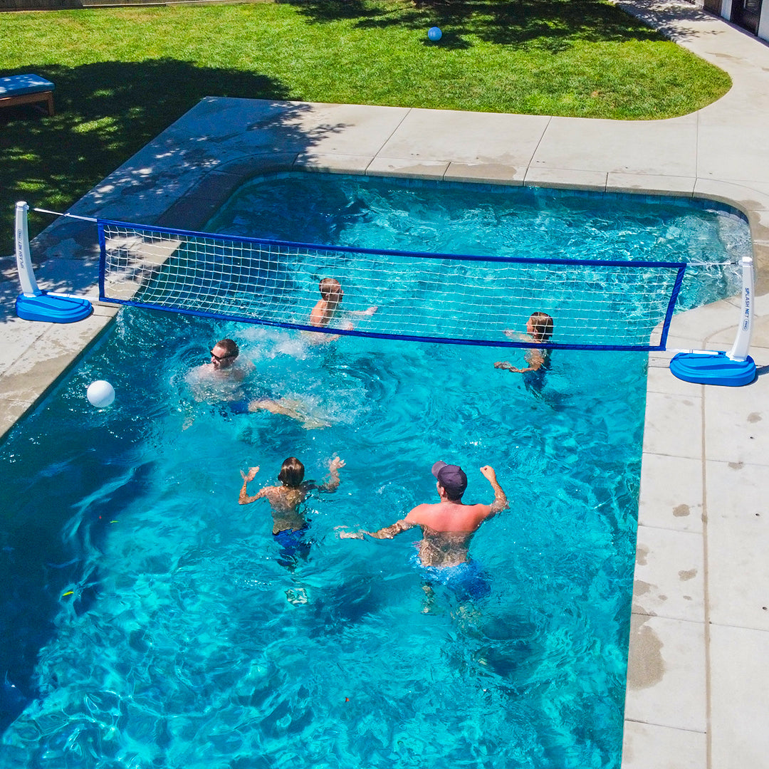 People playing volleyball in a pool with a net