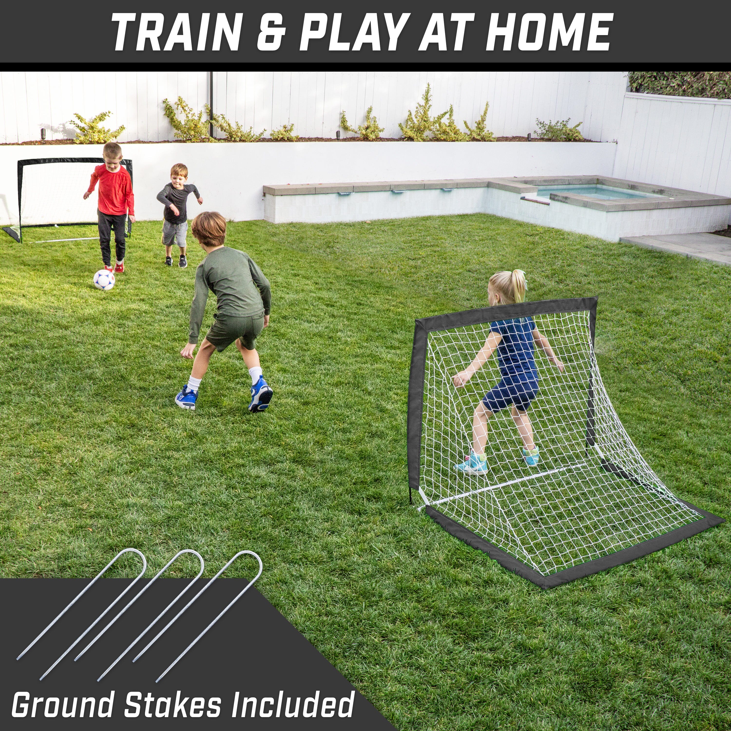 Children playing with a soccer goal in a backyard, with text 'Train & Play at Home' and 'Ground Stakes Included'.